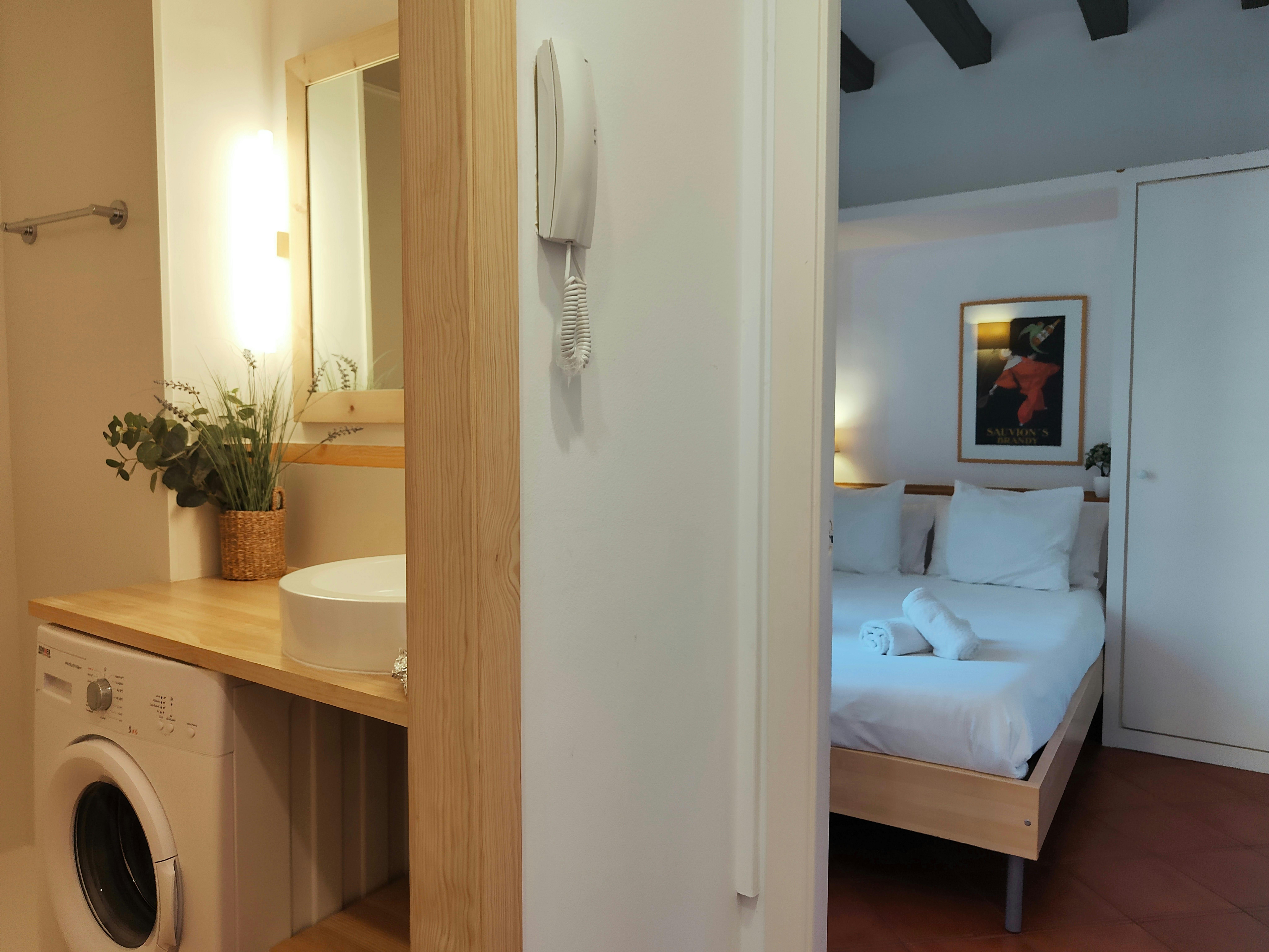 Convenient bathroom by the entrance, includes washing machine and sits beside the double bedroom.