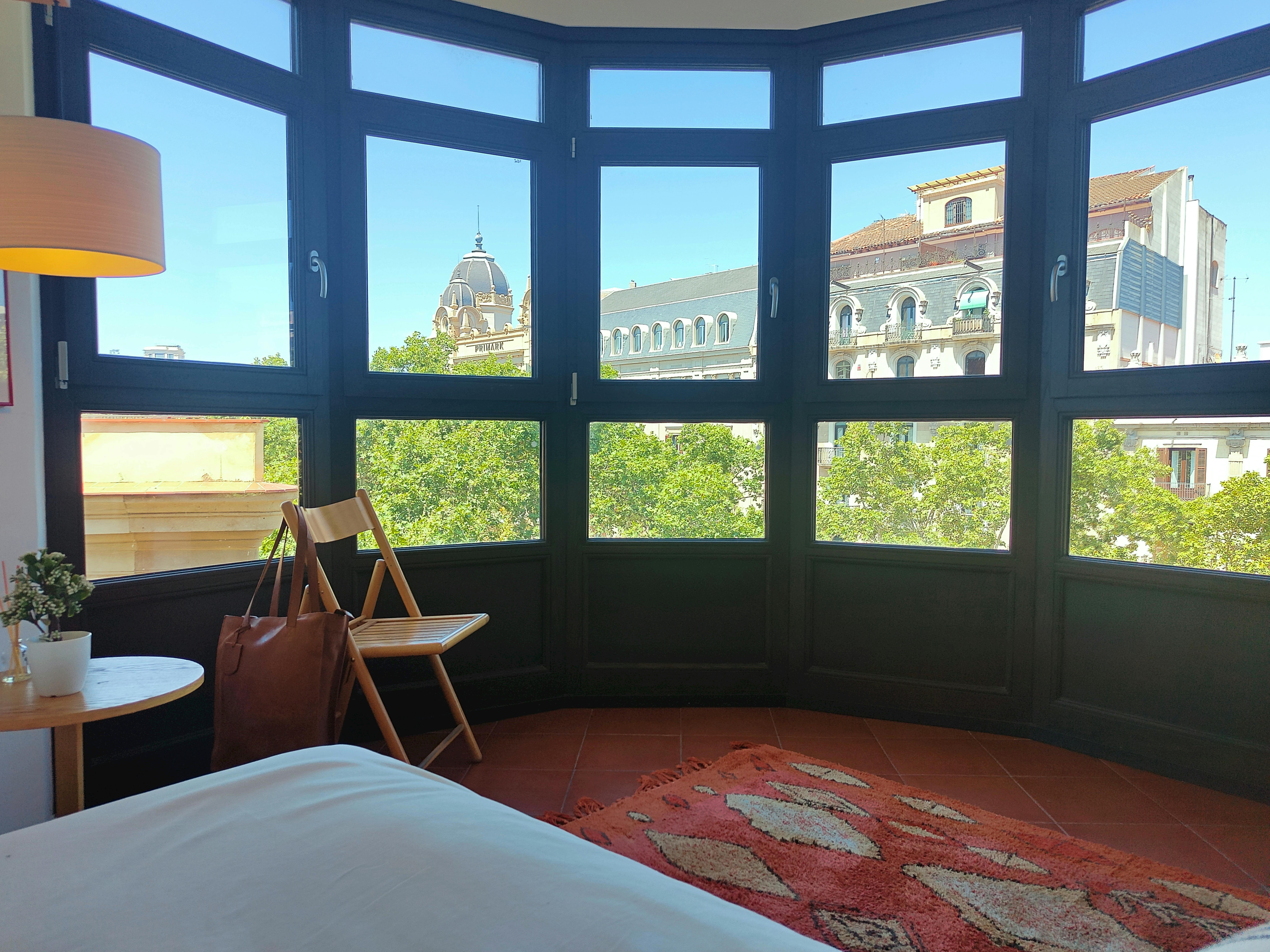 The apartment features a large bay window offering panoramic views of La Rambla.