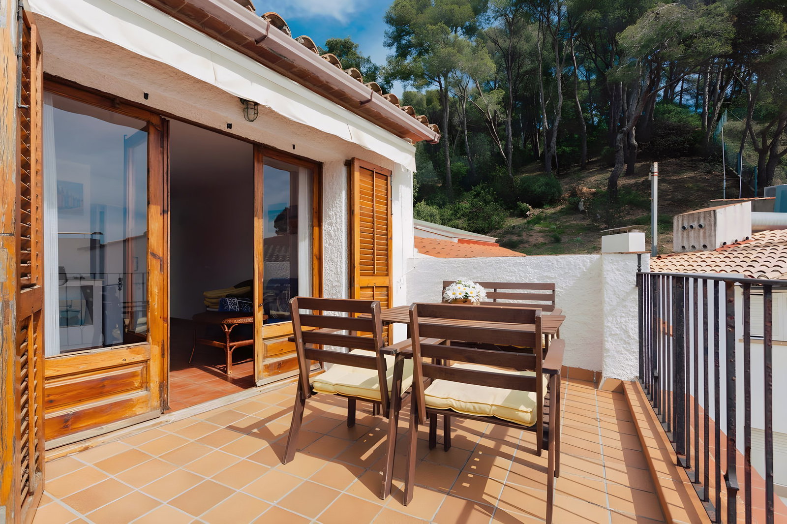Step out onto the spacious terrace and enjoy the views from this penthouse apartment. The terrace is furnished with a table and chairs, perfect for al fresco dining or enjoying a morning coffee. The terrace is also a great place to relax and enjoy the fresh air, with views of the surrounding trees and the sea.