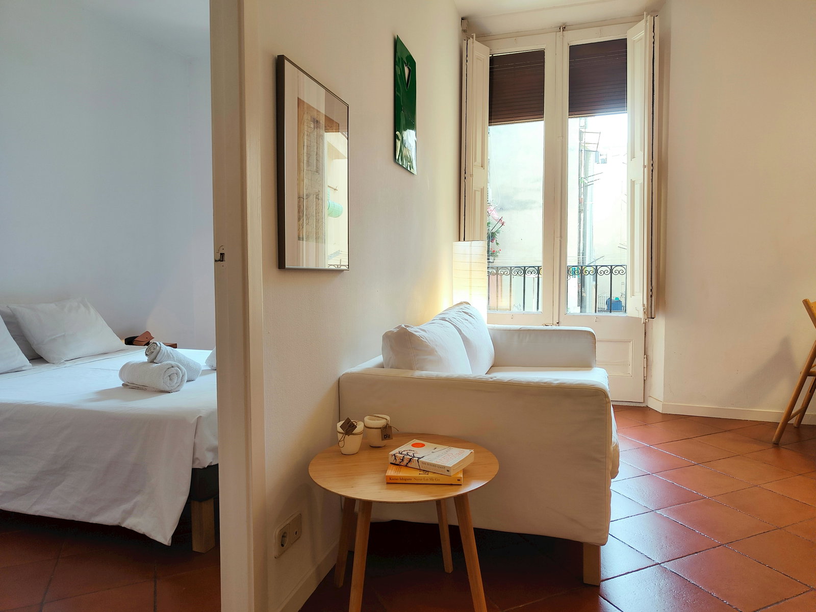 The spacious living area is bathed in natural light streaming through the French balcony doors.