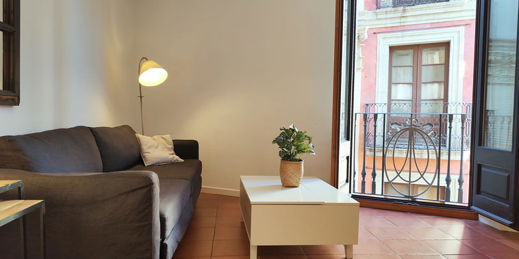 Comfortable living room with dual views of La Rambla and Carrer de Tallers — the city at your feet.