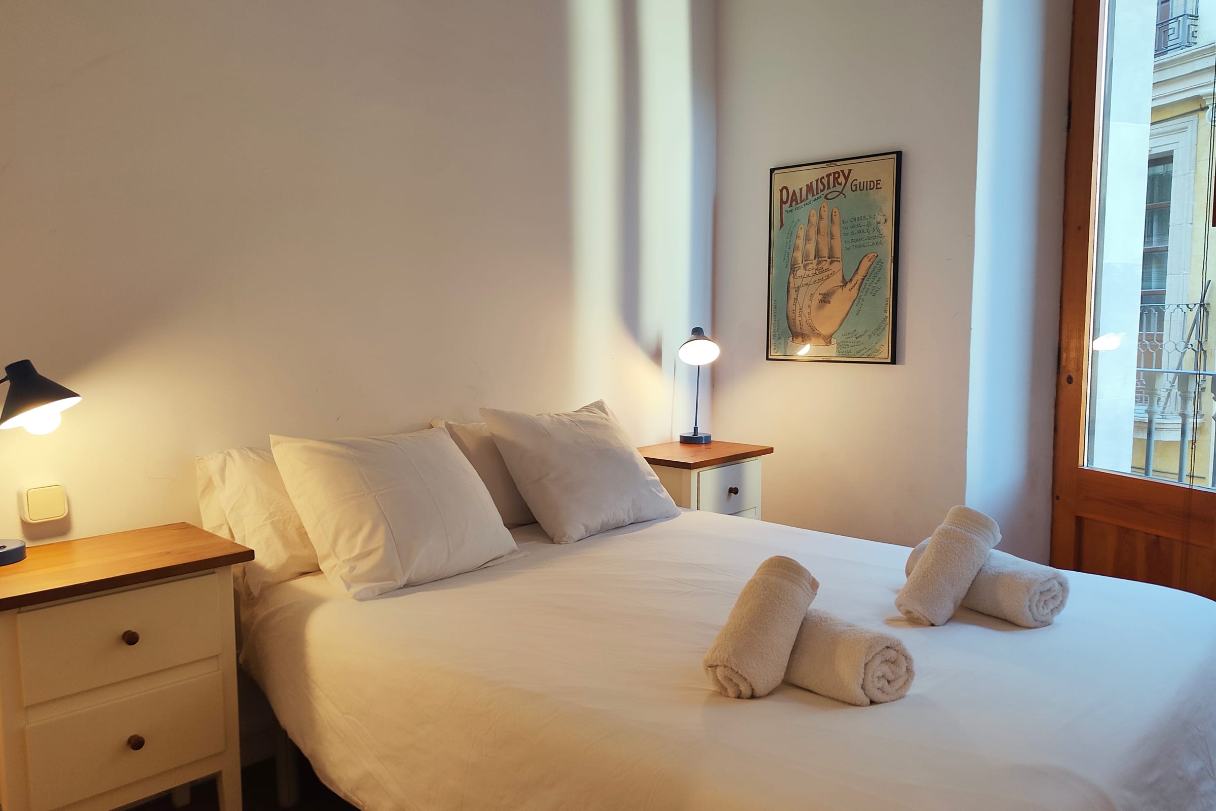 Enjoy a spacious, sunlit double bedroom with direct views of the lively Tallers street.