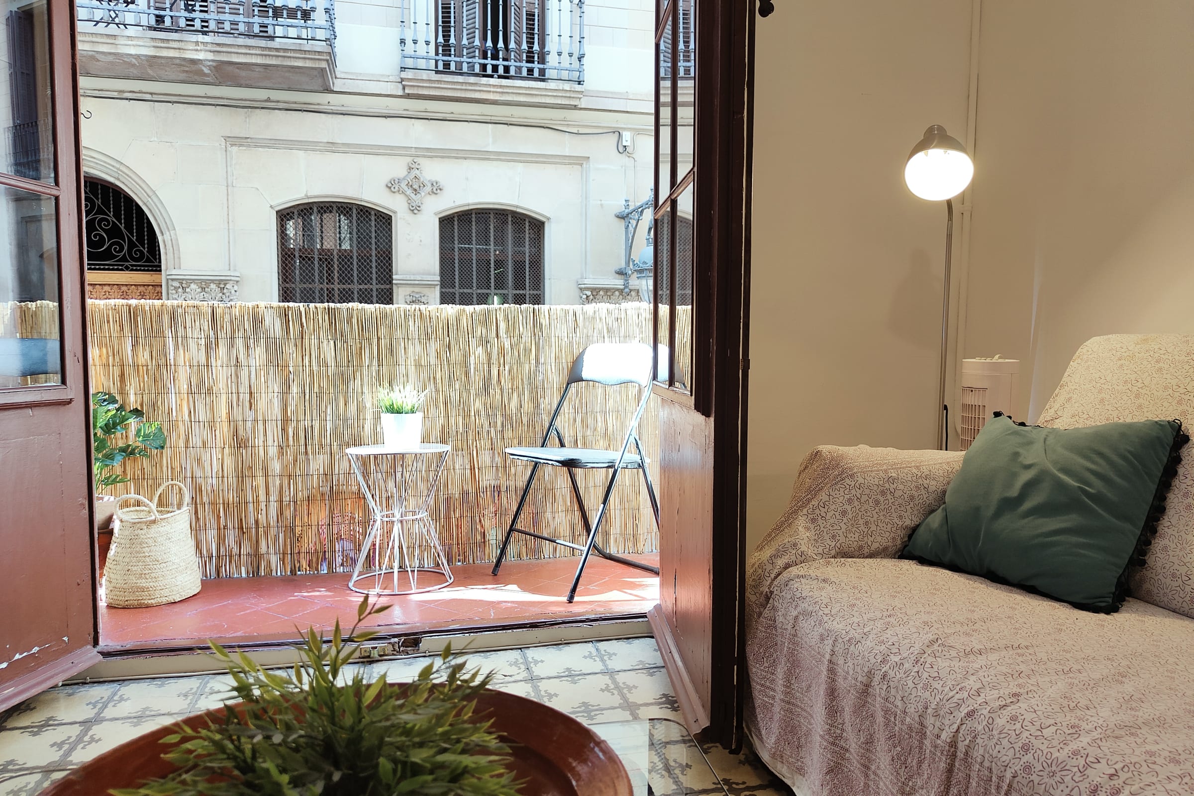 Step out onto the private balcony and enjoy the vibrant city views. The balcony features a small table and chair, perfect for enjoying a morning coffee or an evening drink. The balcony is enclosed with a bamboo screen, providing privacy and a touch of natural charm.