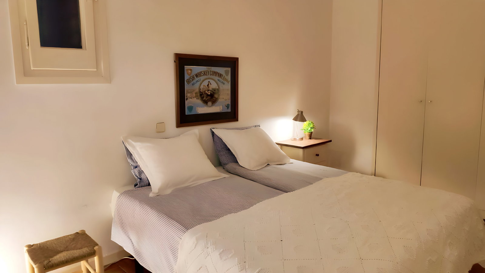 Twin bedroom separated from the living room by a bookshelf for added privacy.