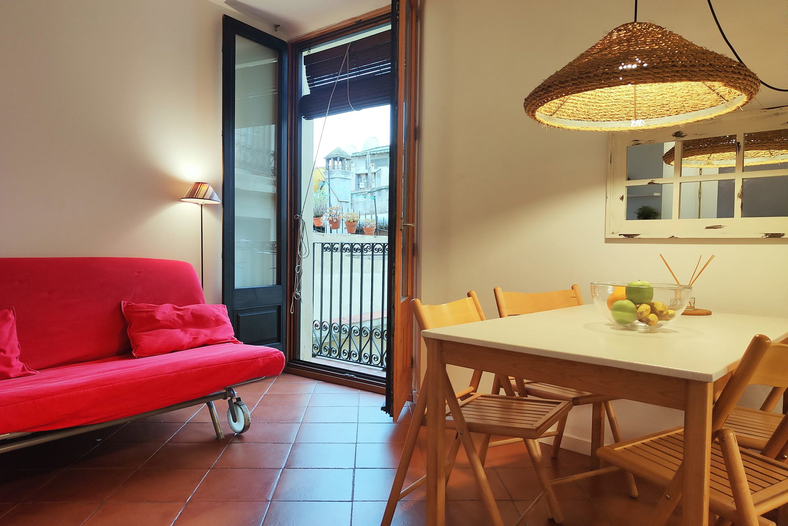 4th floor. The room is bathed in natural light from a set of French doors that open onto a small balcony overlooking a quiet courtyard.