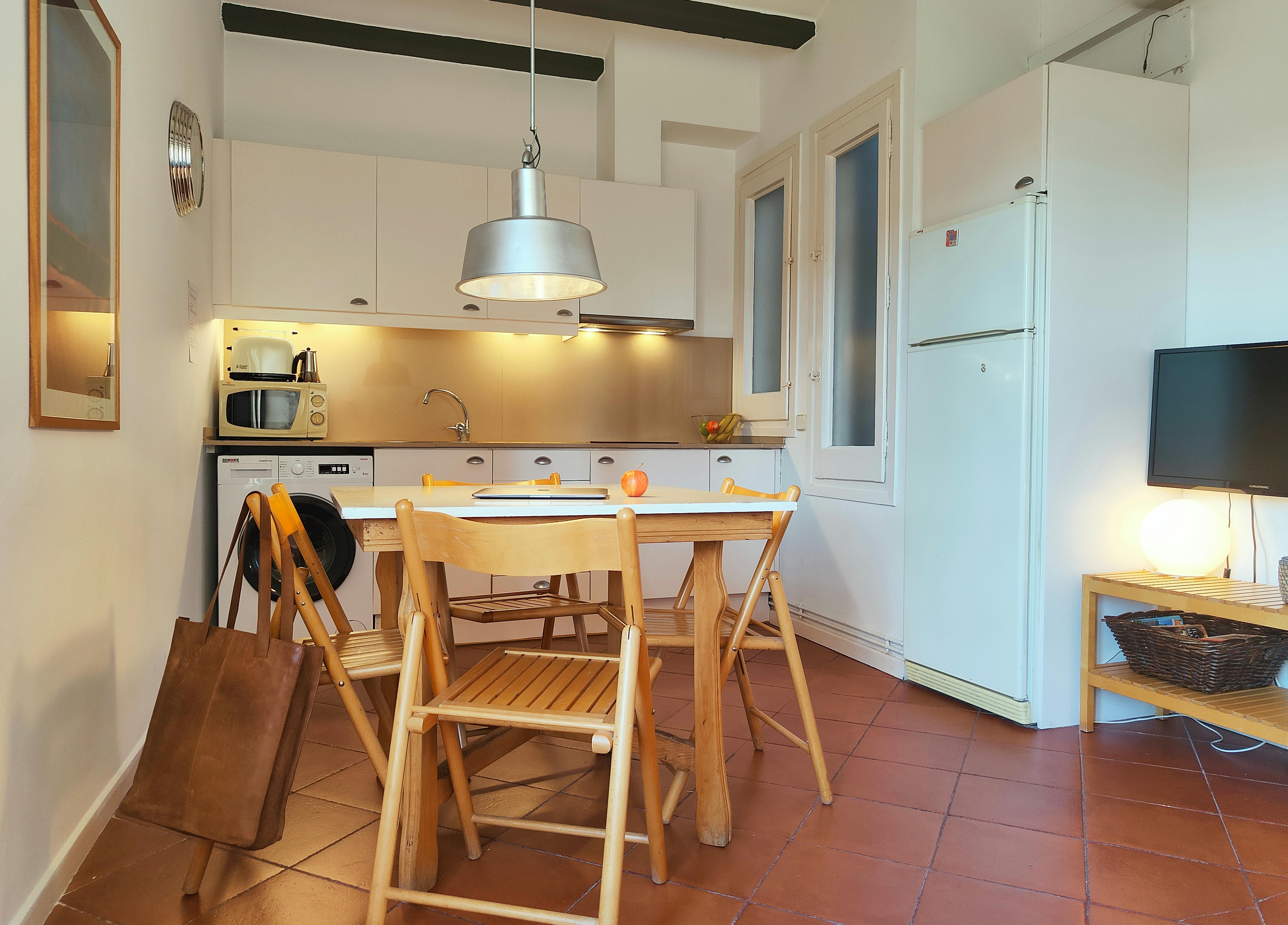 Fully equipped kitchen integrated into the living space, including a washing machine.