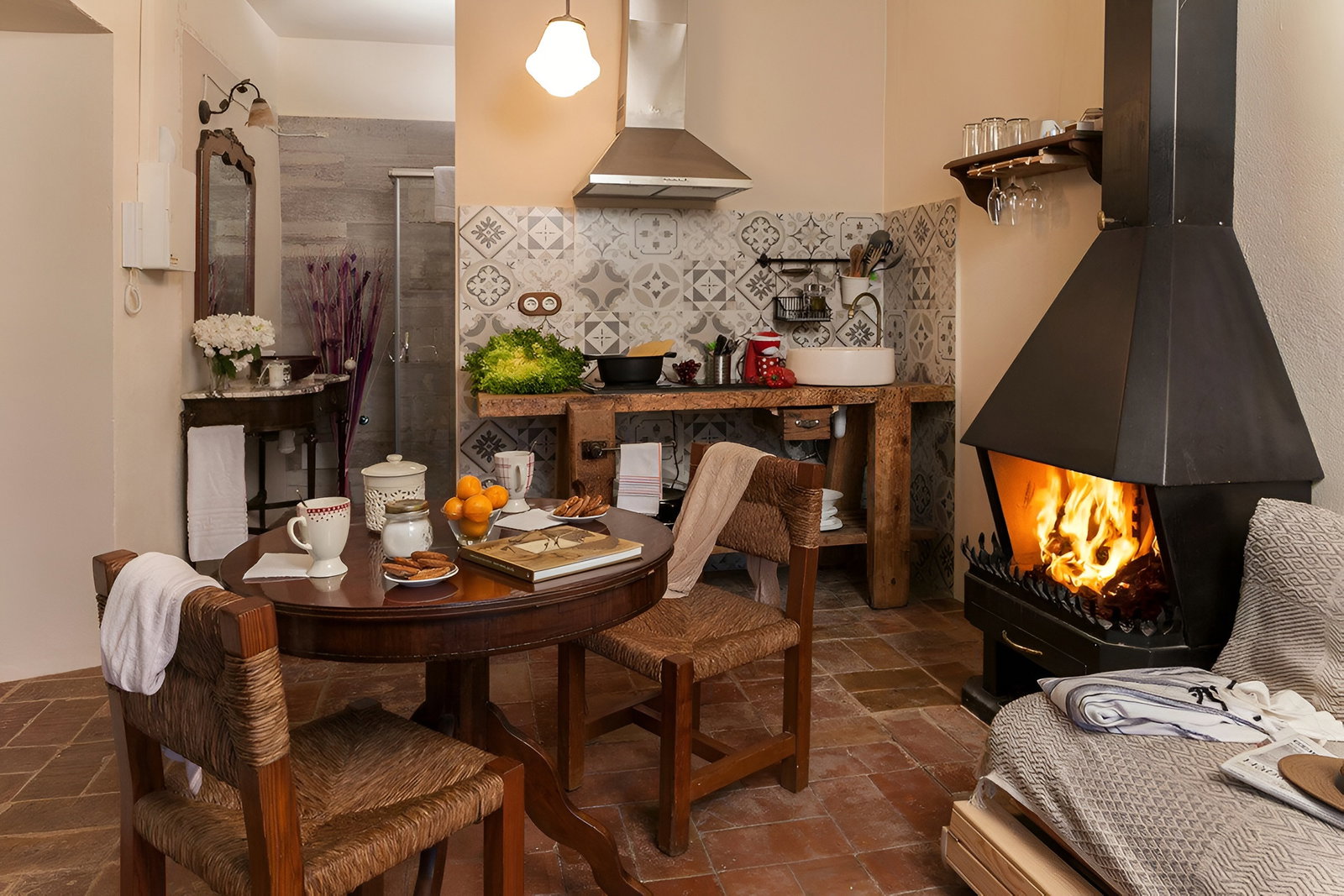 Enjoy your breakfast in this cozy and rustic dining area, highlighted by a roaring fireplace and warm terracotta floors.