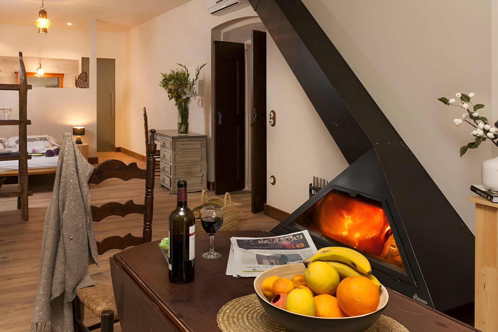 Gather around the modern fireplace in this cozy, open-plan apartment. This warm and inviting space seamlessly blends dining and relaxation.