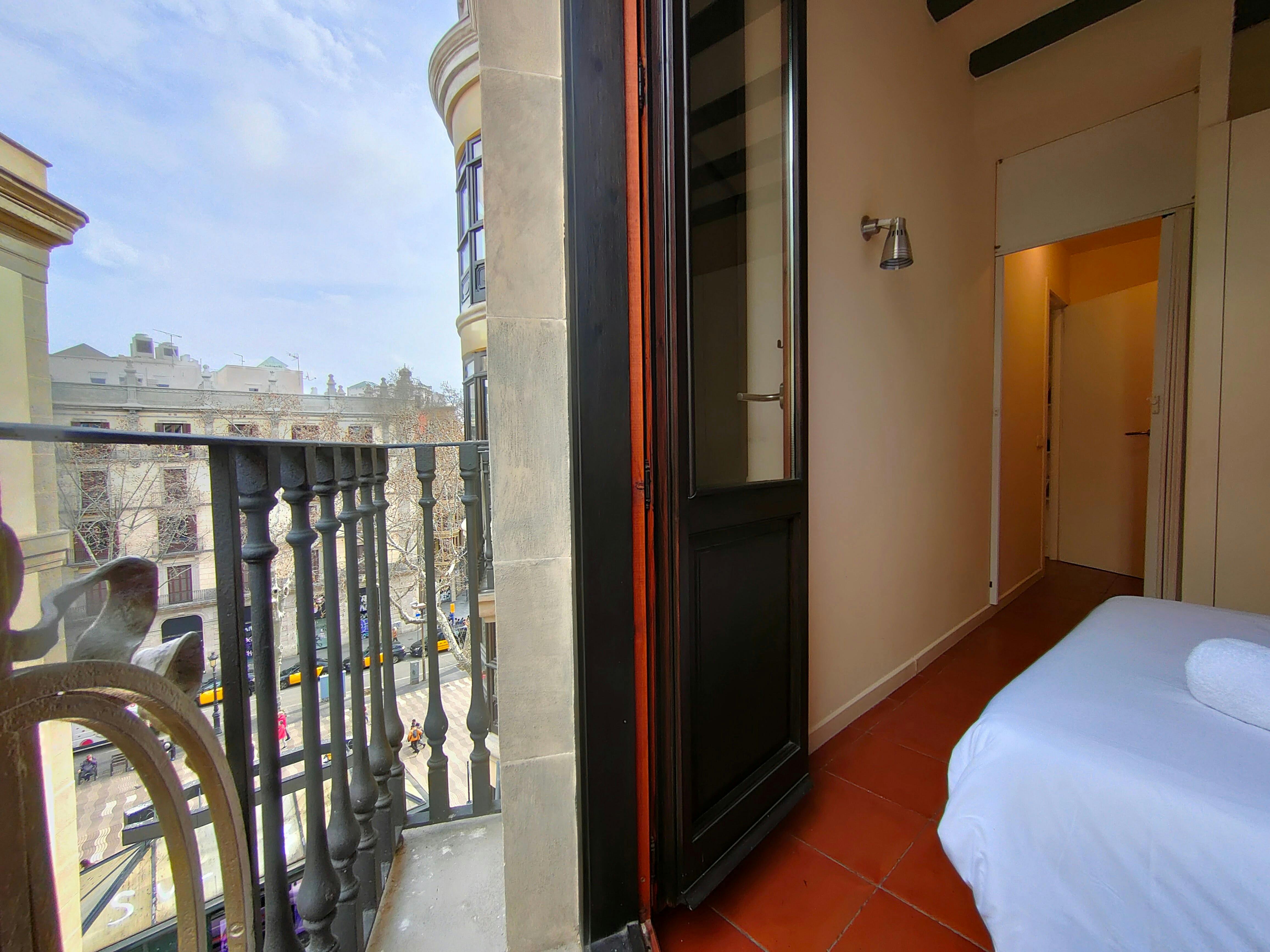 The apartment features two elegant French balconies for fresh air and light.