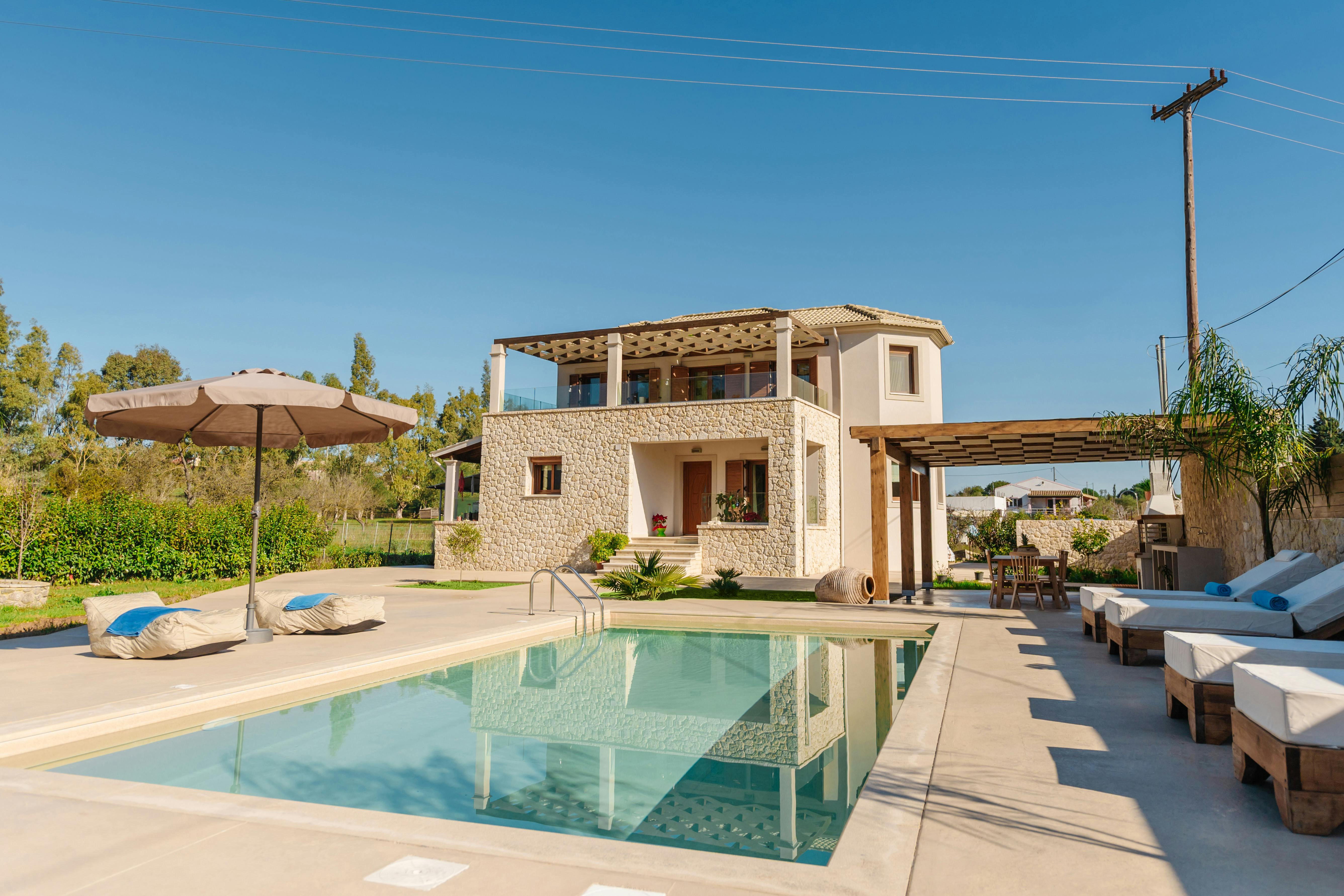 A Luxurious Poolside Retreat: Dive into relaxation at the villa's pristine private pool, surrounded by serene views.