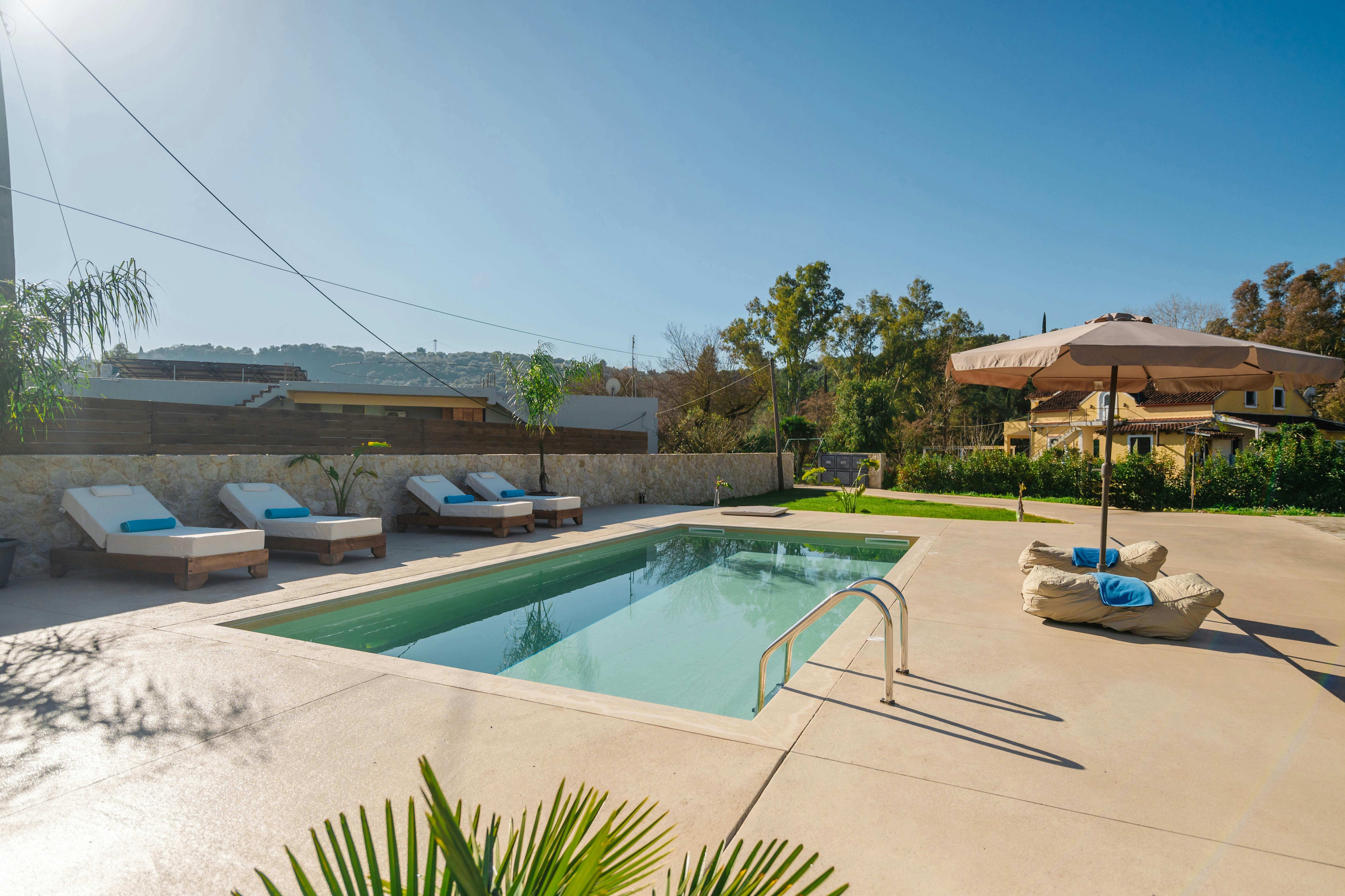 A Luxurious Poolside Retreat: Dive into relaxation at the villa's pristine private pool, surrounded by serene views.