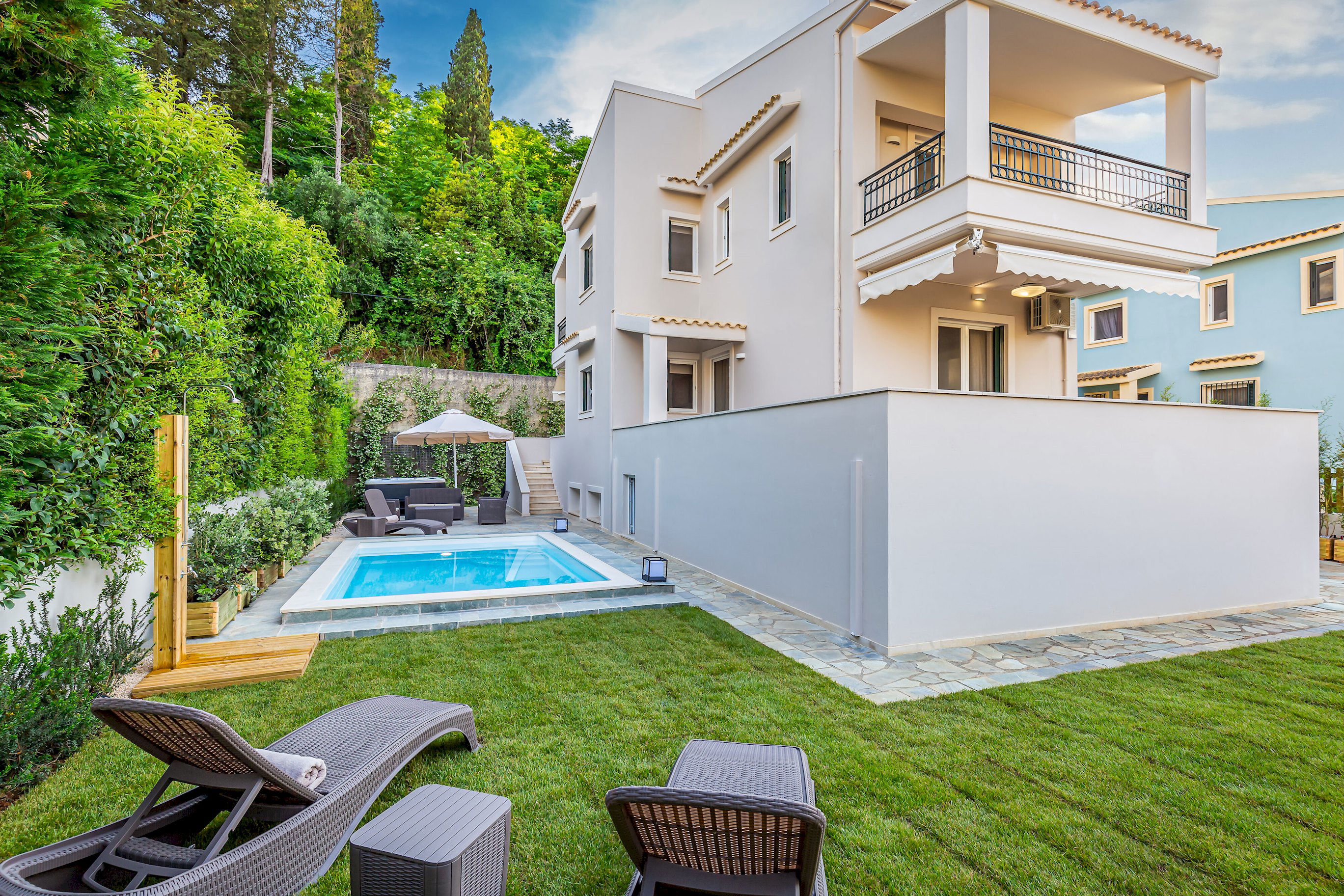 "Welcome to House Magdalena! A tranquil retreat nestled amidst lush greenery and a sparkling pool."