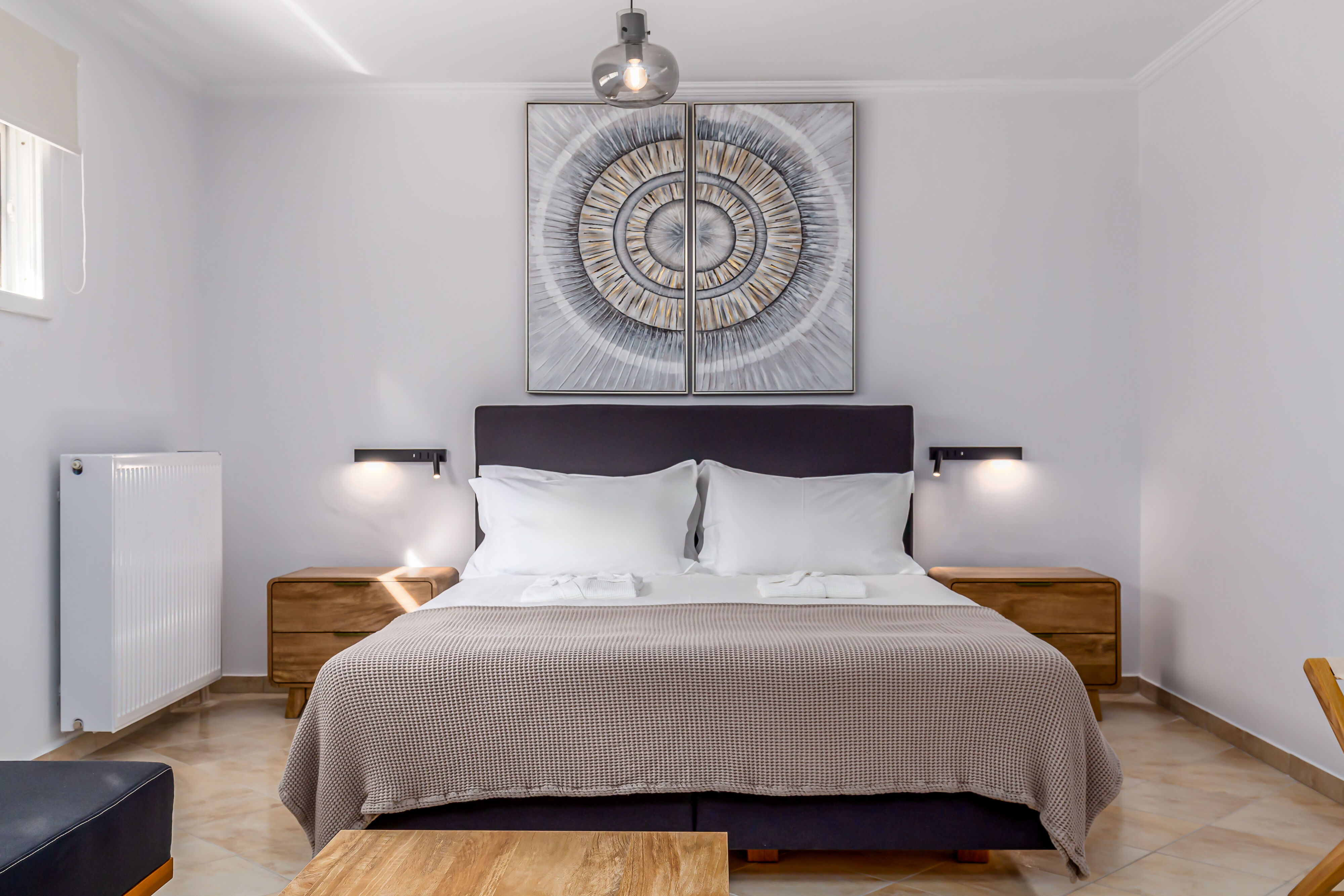 "Indulge in comfort and relaxation in our upper floor bedrooms, where cozy double beds await alongside convertible single beds, ensuring a restful night's sleep. Enjoy modern amenities like TVs, A/C, and ample storage space, with private balconies."