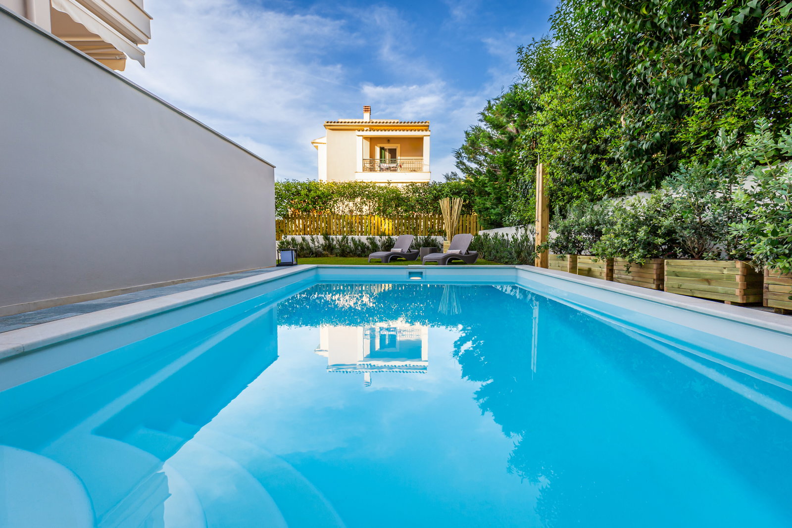 "Indulge in outdoor luxury in our private garden sanctuary, boasting a refreshing pool, heated jacuzzi, and verdant surroundings."