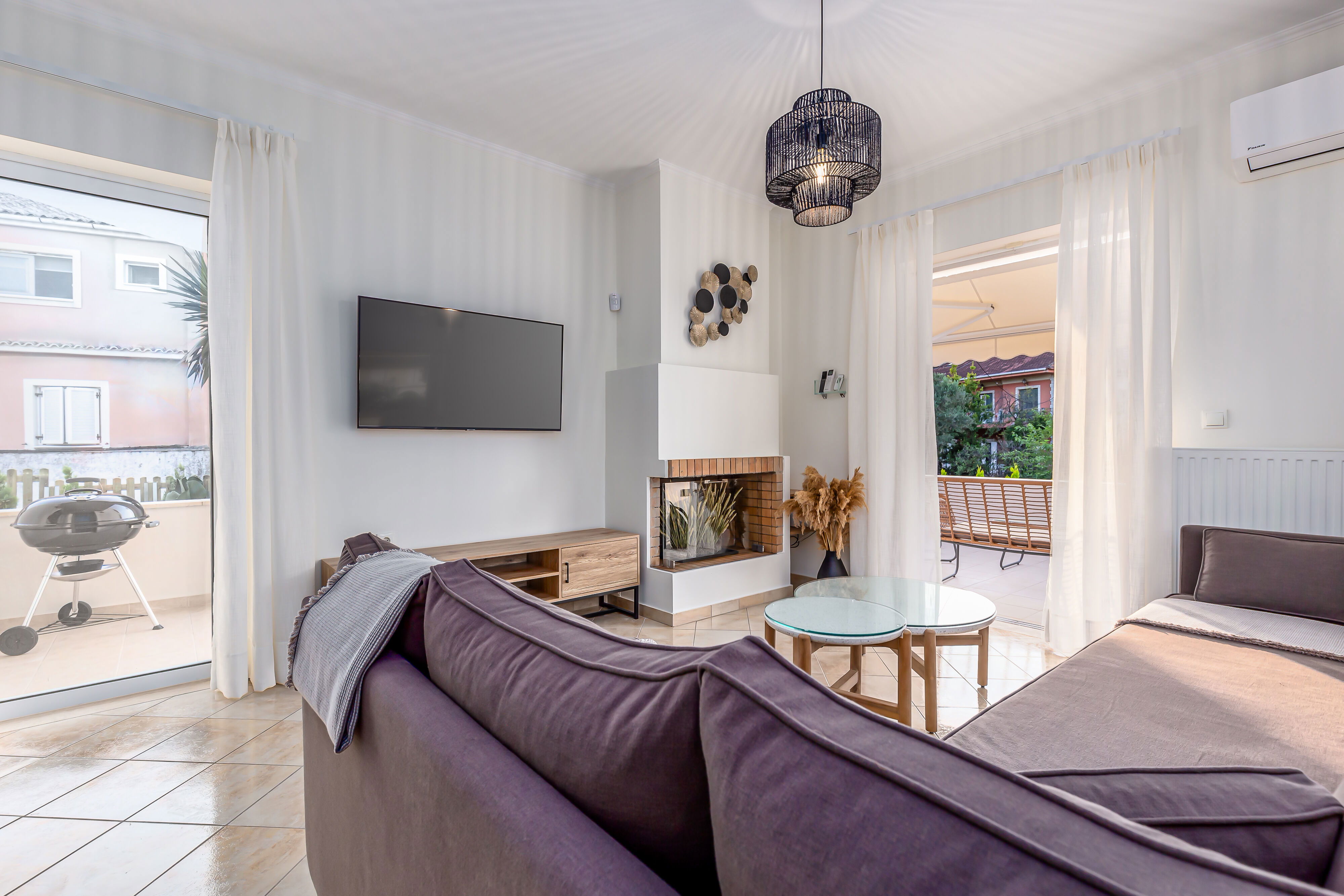 "Relax in style in our spacious living room, featuring a sleek modern design, a cozy fireplace, and ample seating for all."