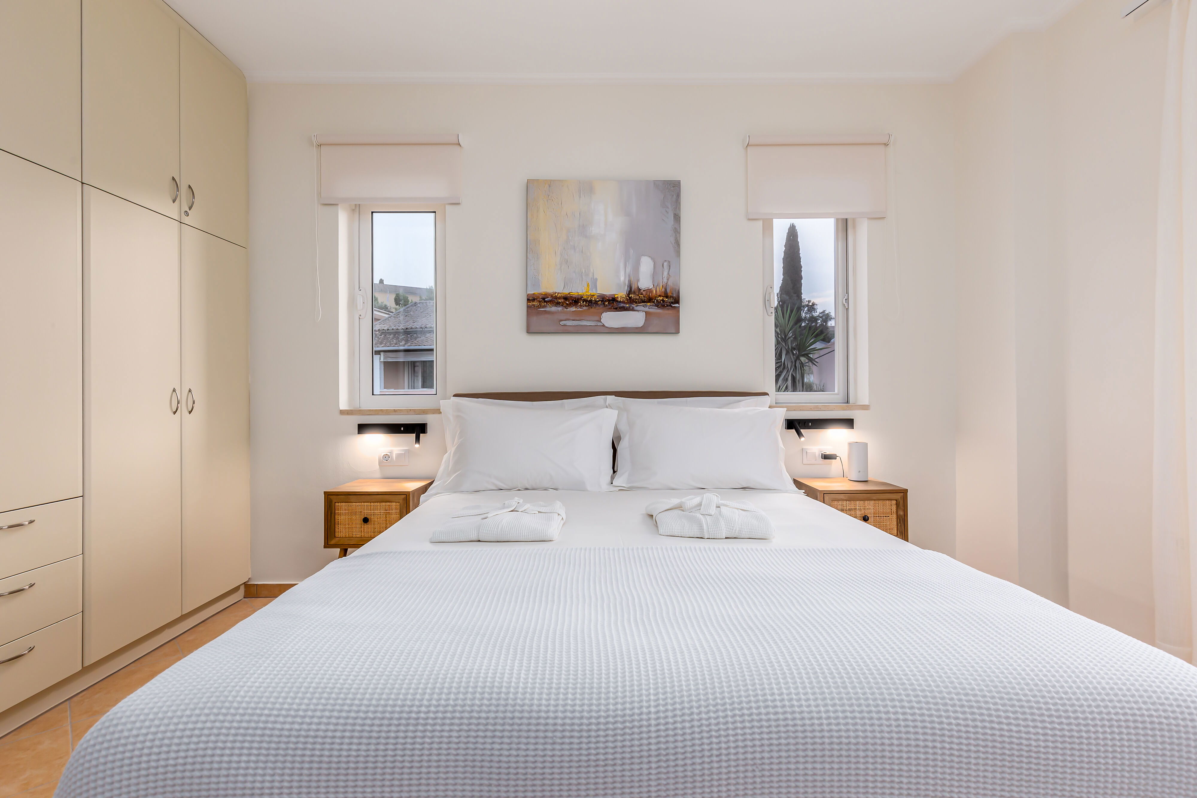 "Indulge in comfort and relaxation in our upper floor bedrooms, where cozy double beds await alongside convertible single beds, ensuring a restful night's sleep. Enjoy modern amenities like TVs, A/C, and ample storage space, with private balconies."