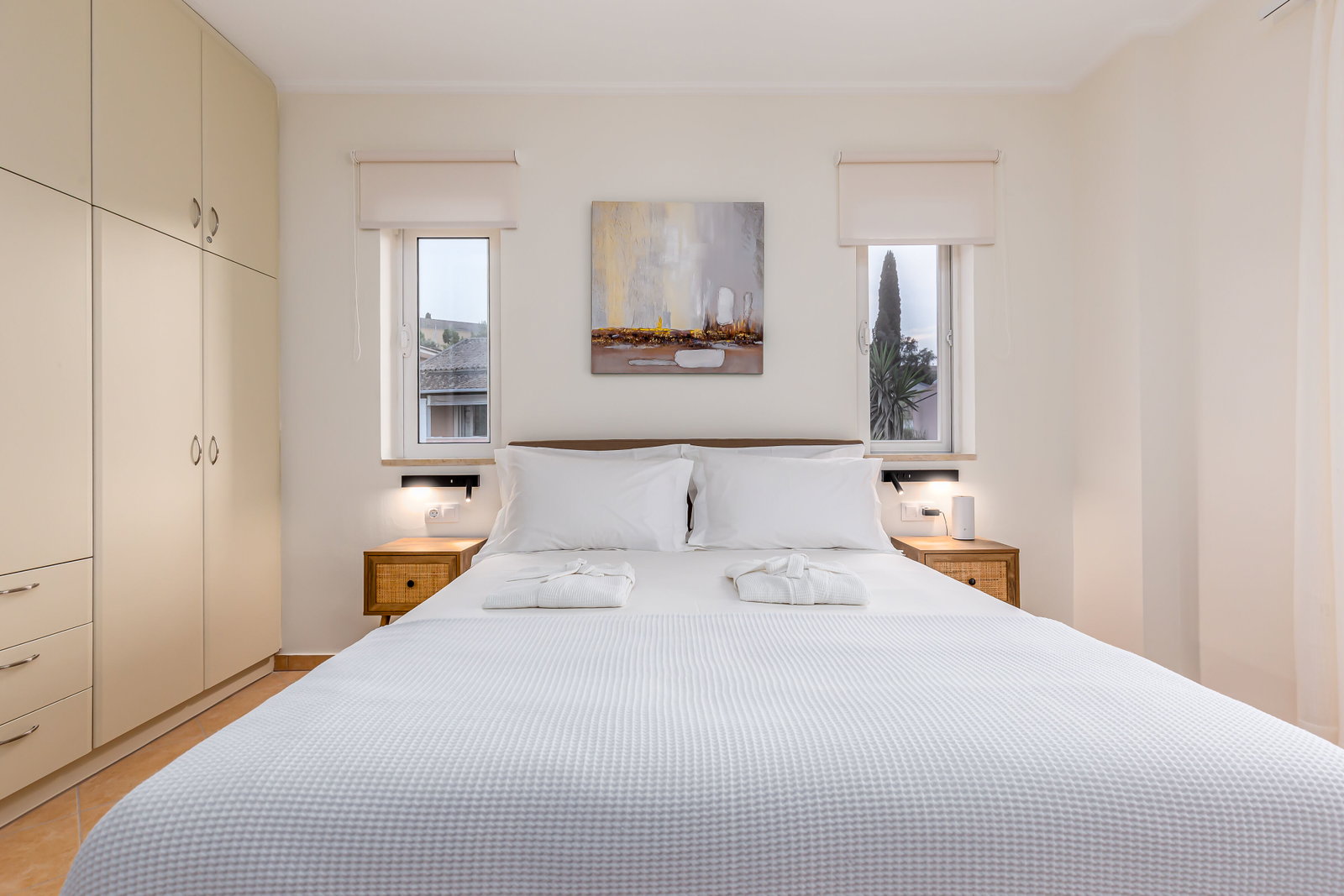 "Indulge in comfort and relaxation in our upper floor bedrooms, where cozy double beds await alongside convertible single beds, ensuring a restful night's sleep. Enjoy modern amenities like TVs, A/C, and ample storage space, with private balconies."