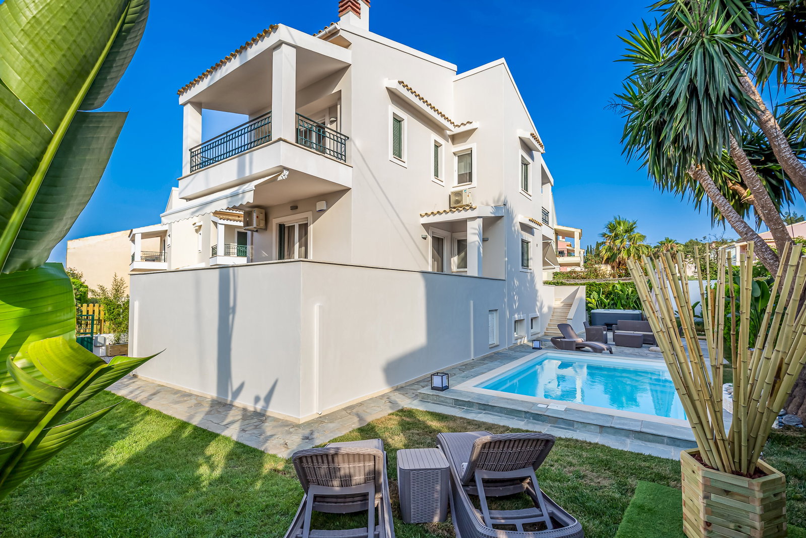 "Welcome to House Anastasia! A tranquil retreat nestled amidst lush greenery and a sparkling pool."
