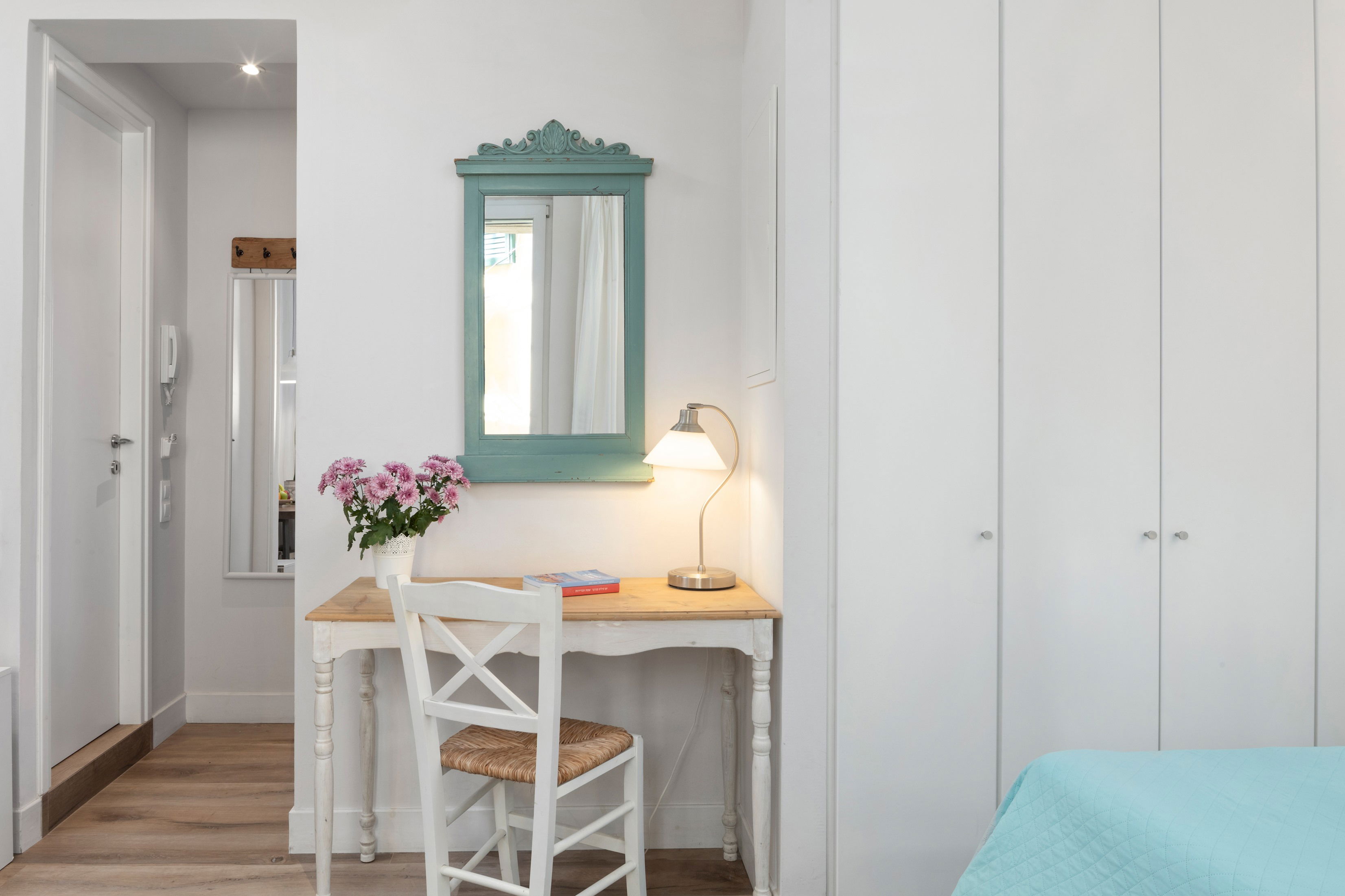 "Find inspiration at our charming desk, accompanied by a traditional Greek chair."