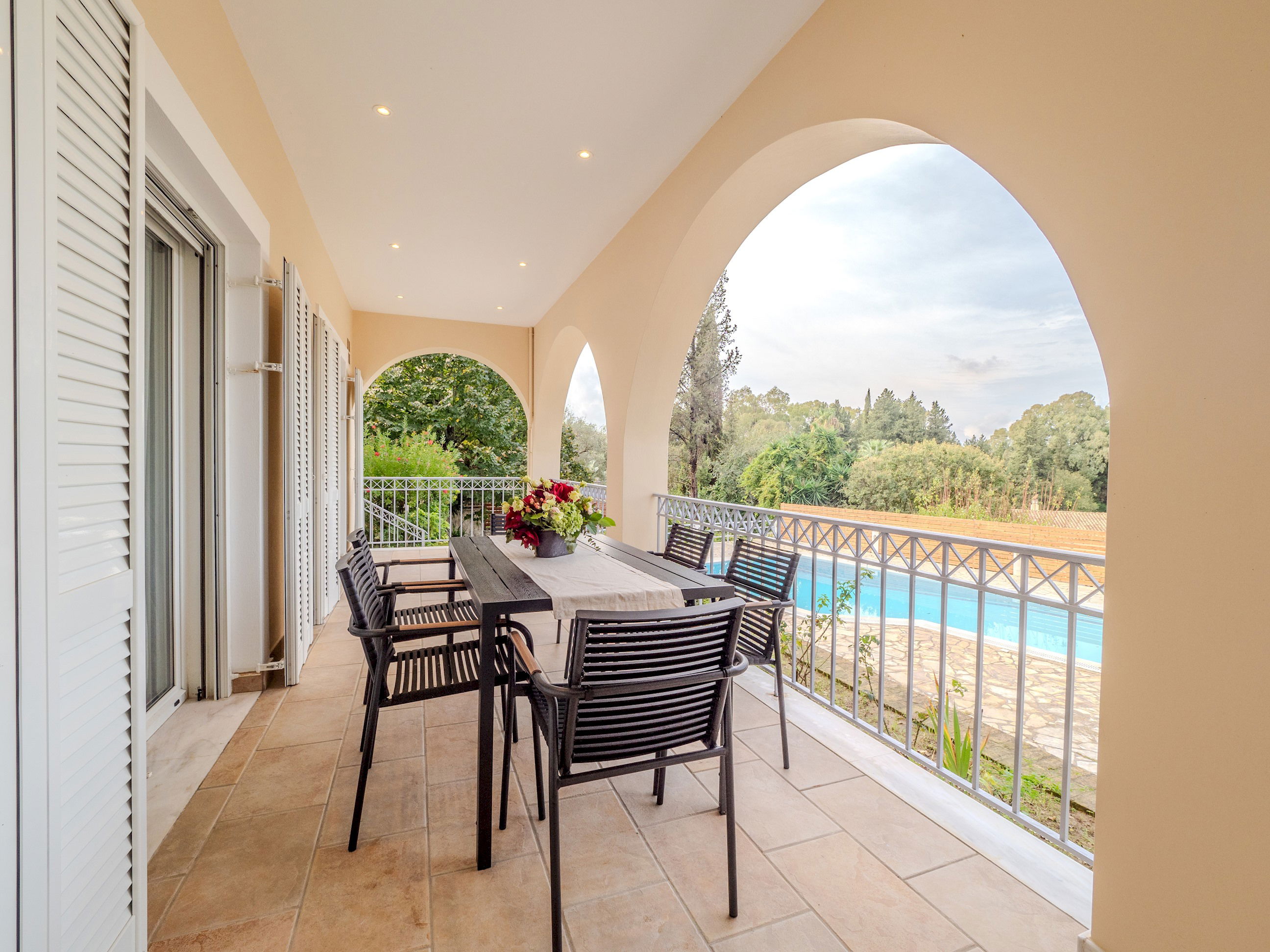 "Savor the tranquility of our outdoor oasis, where the soothing sounds of nature accompany every dip in the pool."