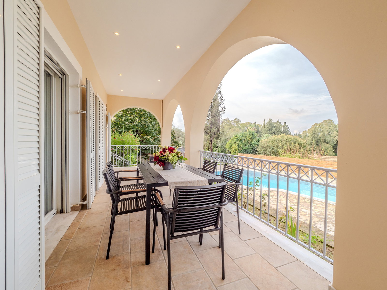 "Enjoy alfresco dining with friends and family on our spacious veranda, offering a picturesque setting for memorable moments."