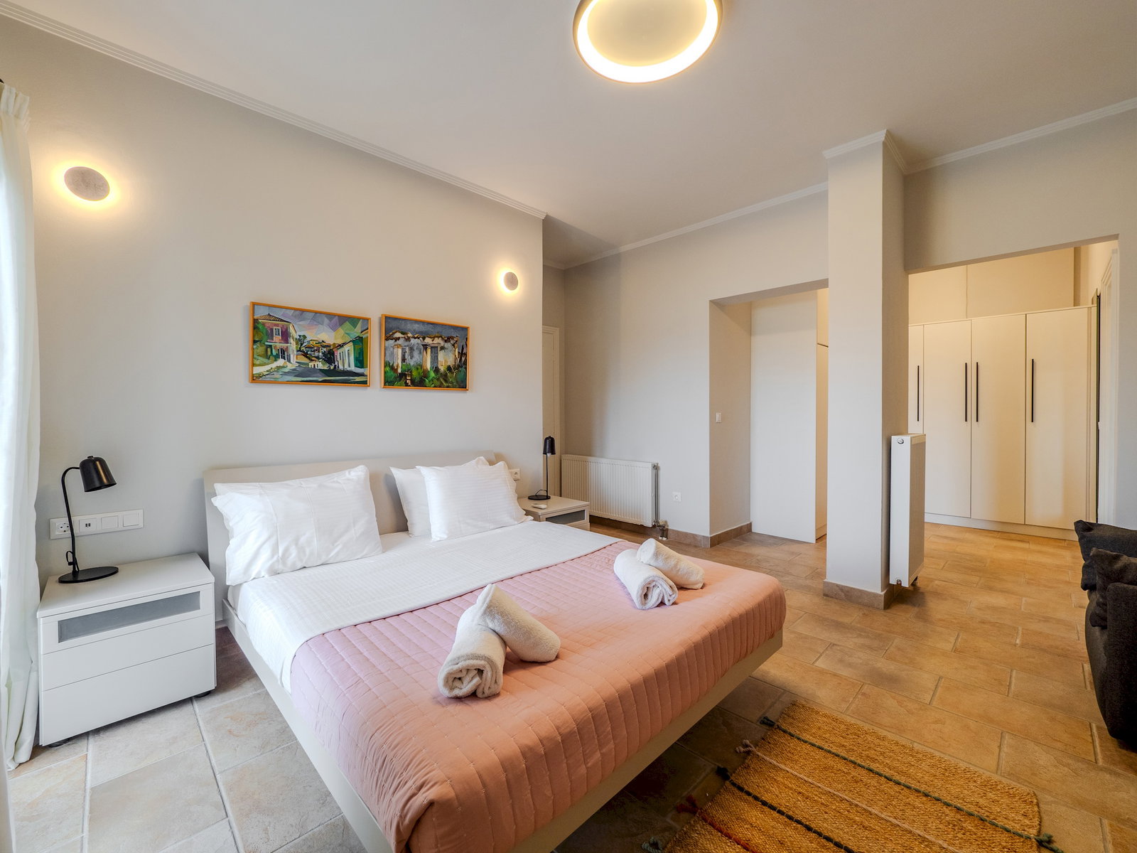 "Indulge in the epitome of comfort and style as you unwind in this chic bedroom haven, adorned with tasteful furnishings and soothing ambiance"