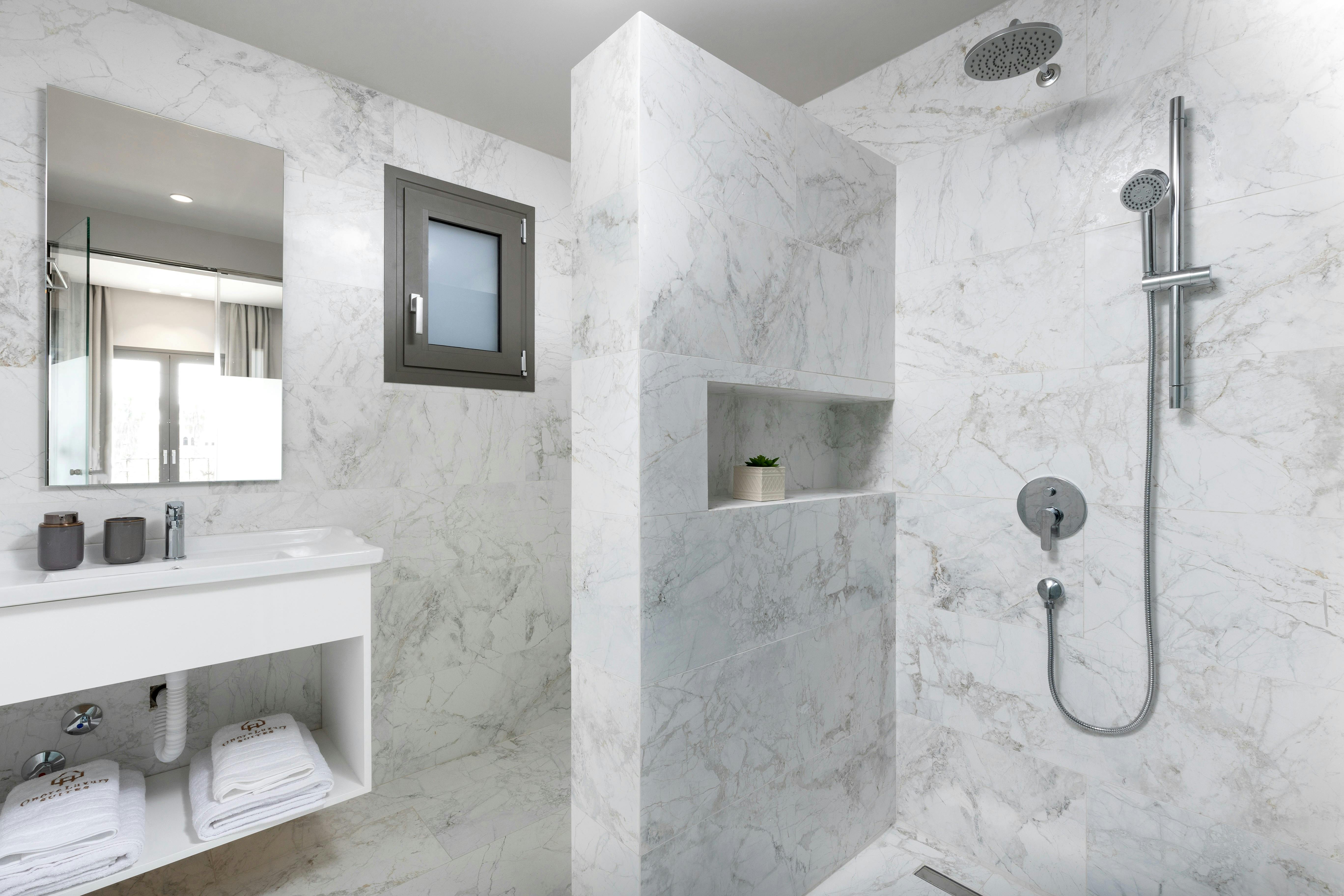 "Step into luxury: Our sleek marble bathroom offers a spa-like retreat to refresh and recharge."