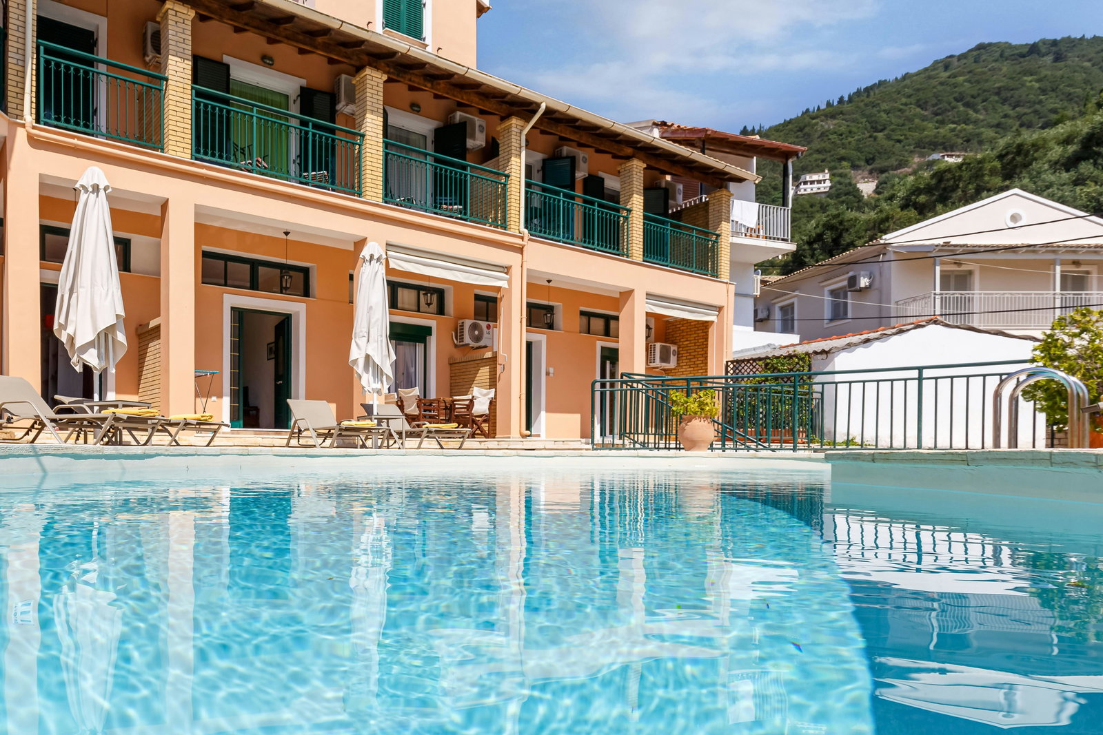 "Villas Delphine and Nikos By Tsiolis Family next to each other. Relax by the large shared swimming pool with sunbeds and umbrellas, perfect for unwinding under the Corfiot sun."