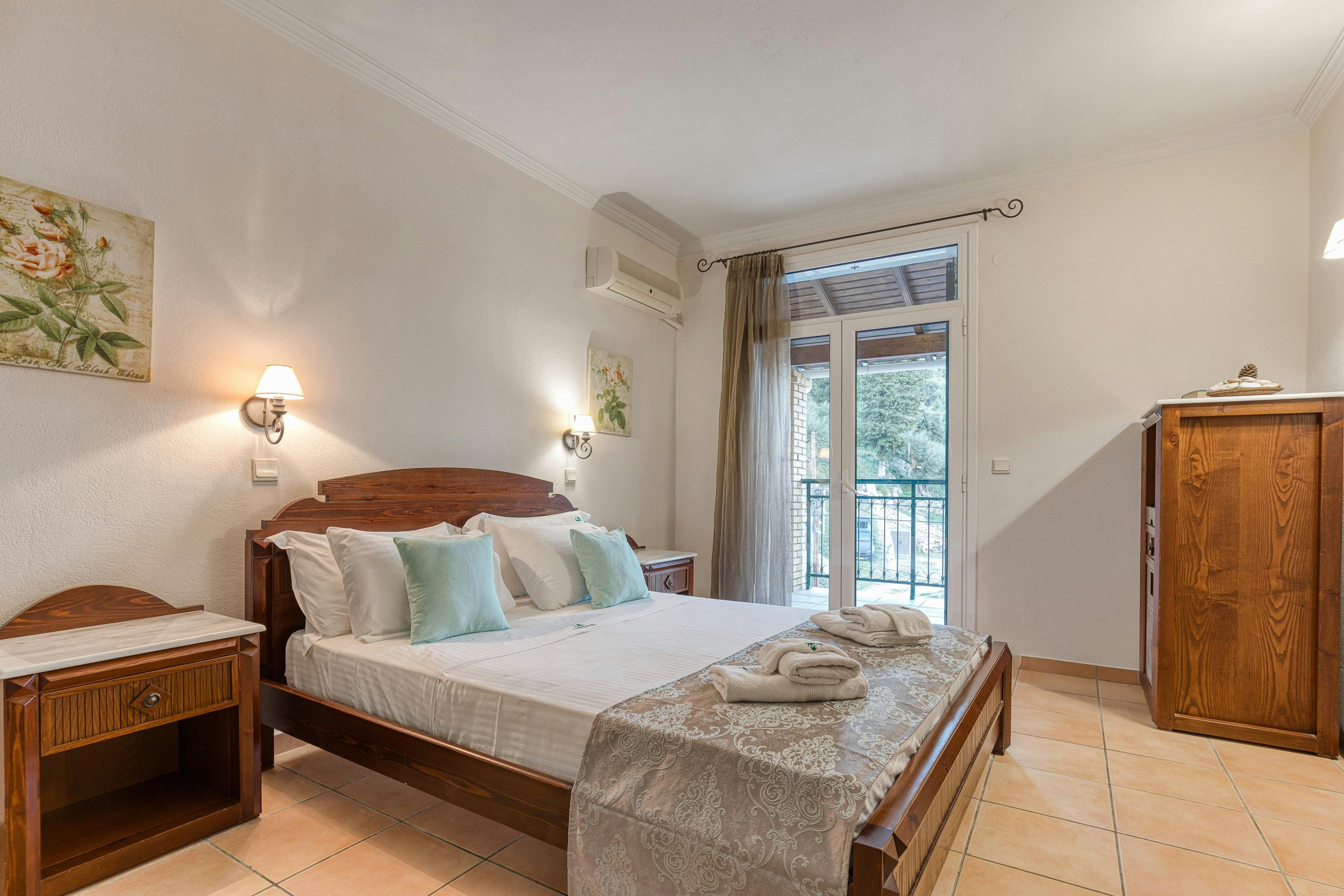 "Spacious and cozy bedroom with natural light and comfortable bedding for a restful sleep."