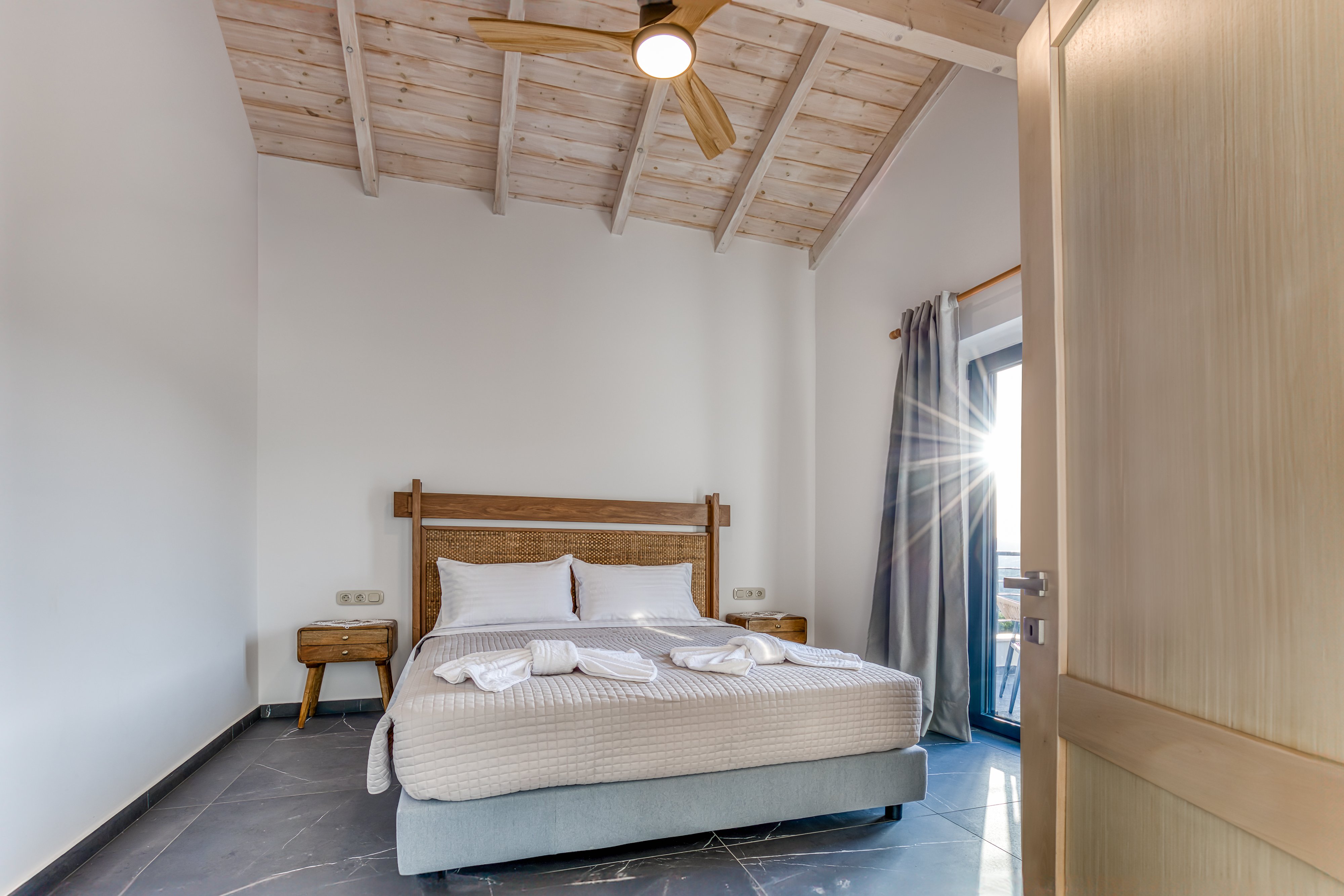 "Unwind in our elegantly designed bedroom, featuring a cozy king-sized bed and natural light."