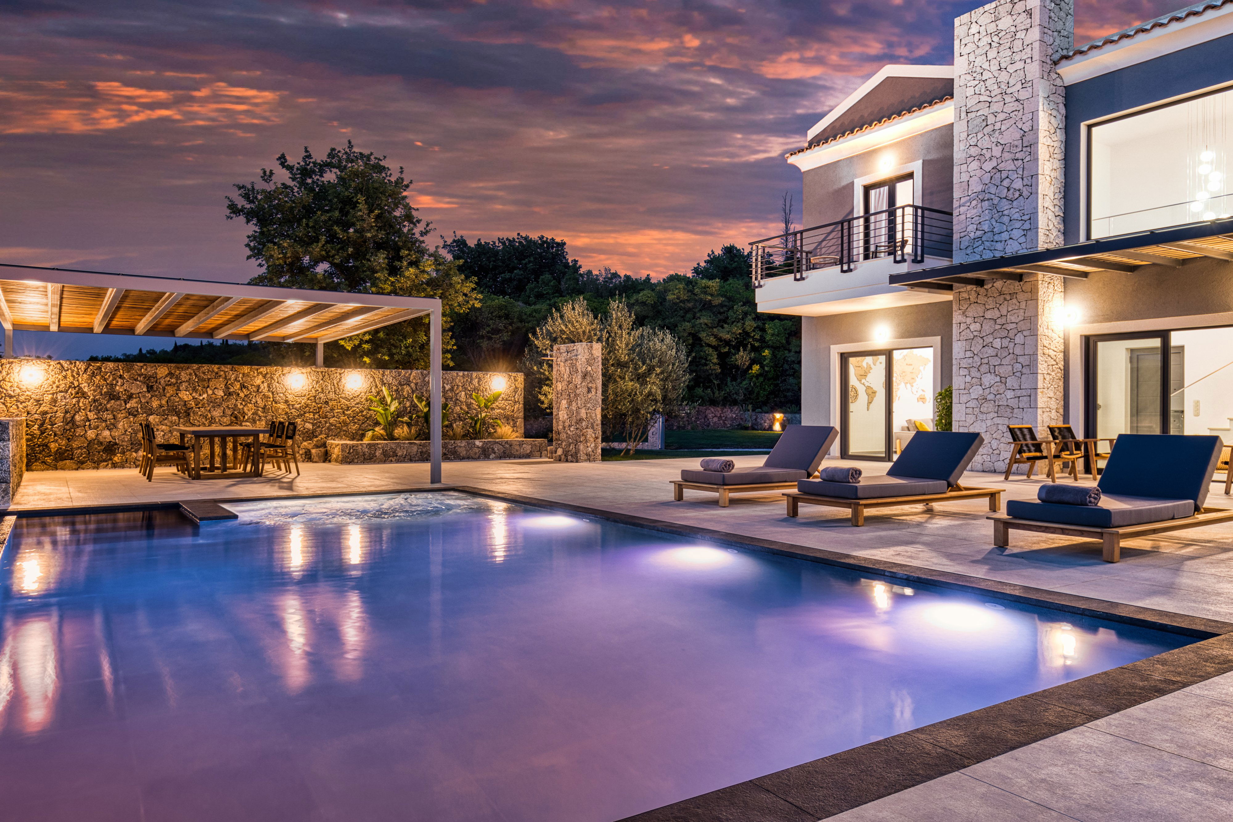 "Stunning villa exterior at sunset, inviting you for a memorable stay."