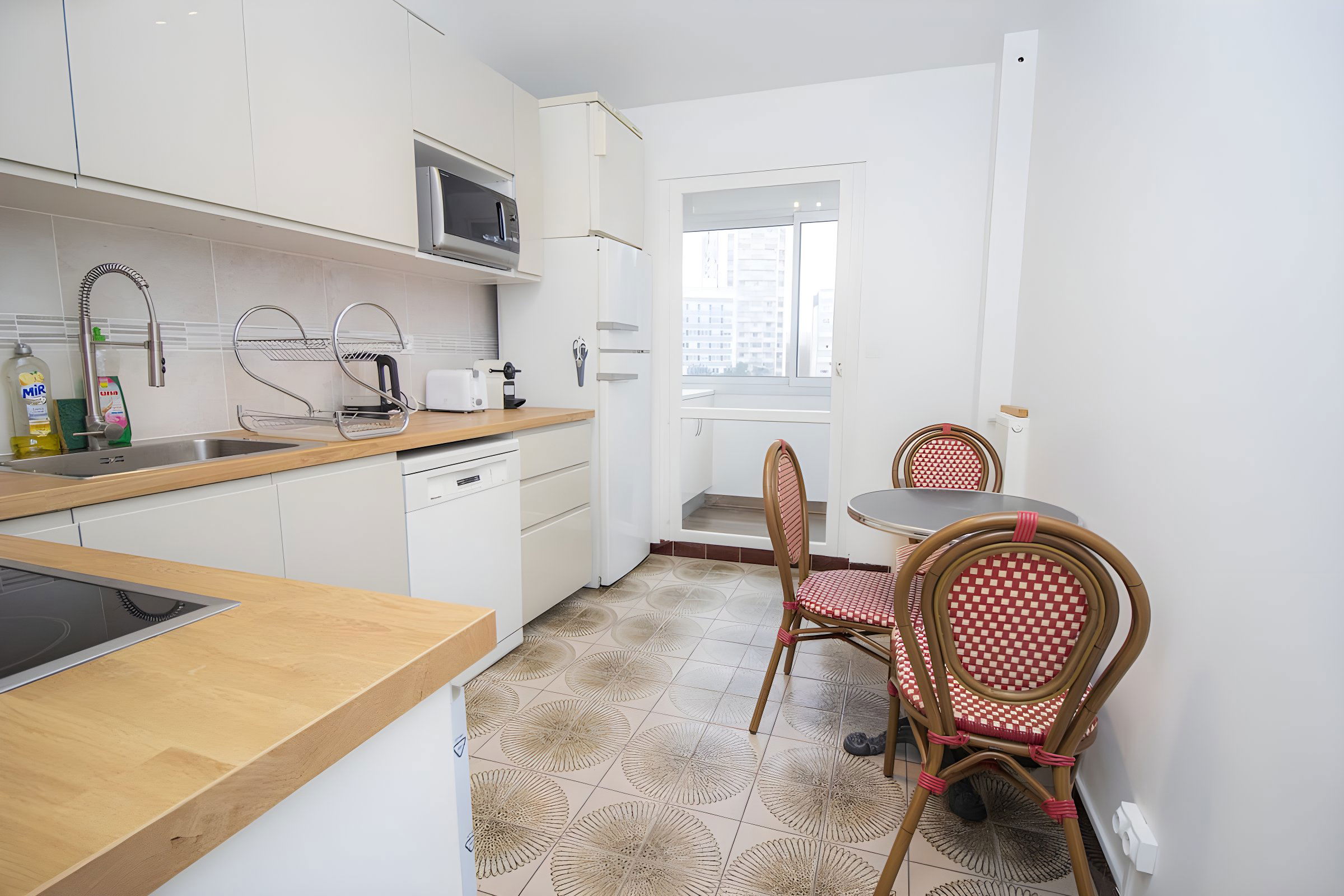 small dining area with authentic Parisian bistro table 