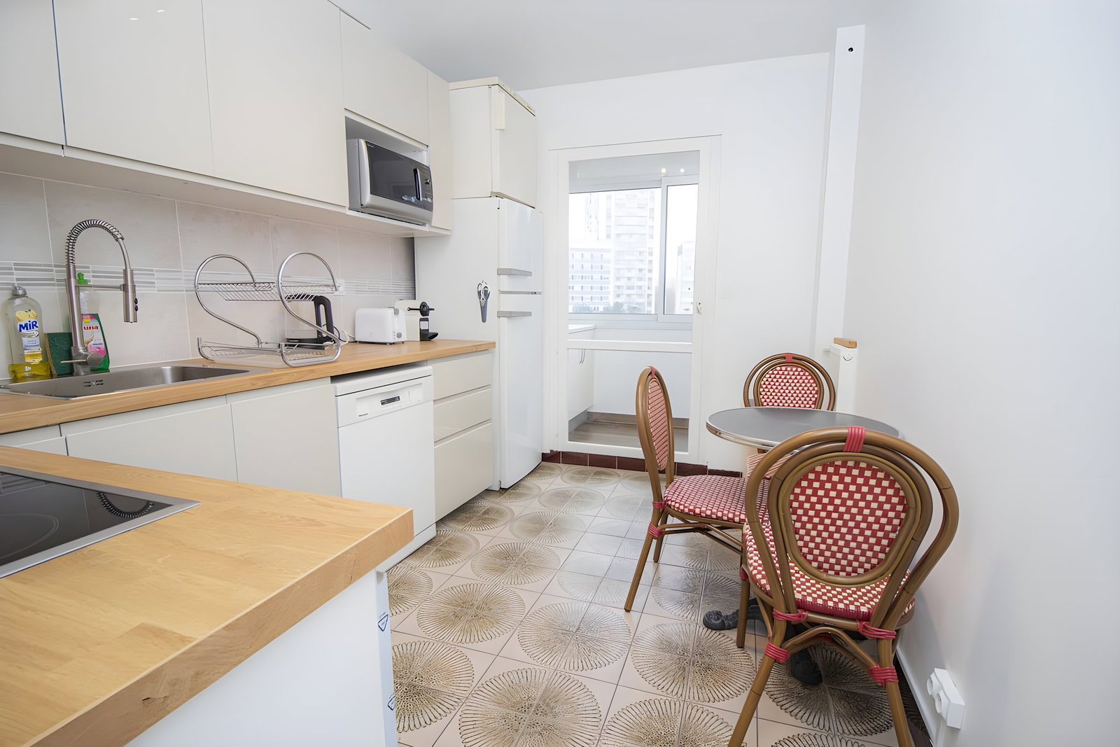 small dining area with authentic Parisian bistro table 