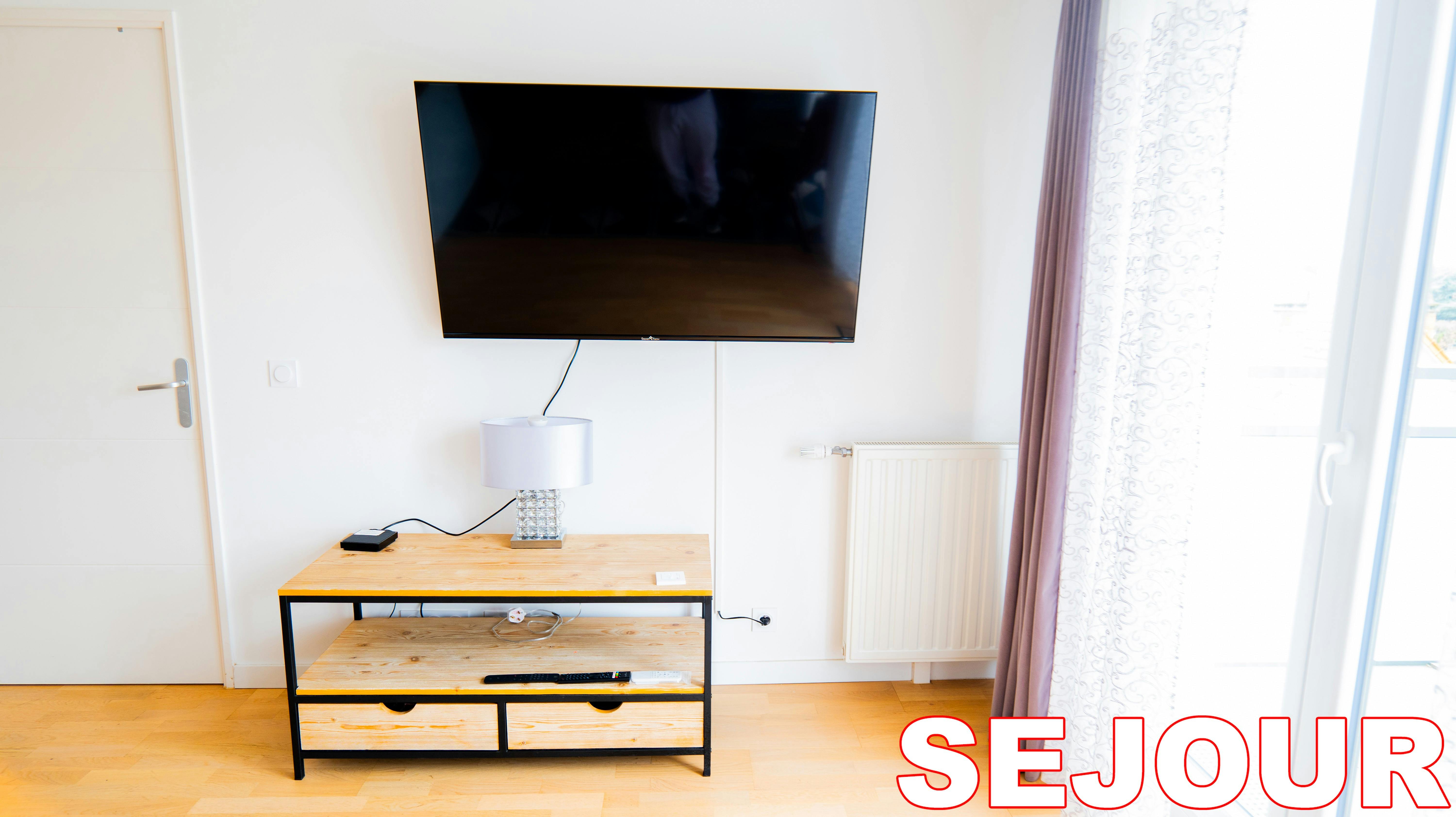 Unwind in the chic comfort of this modern living room, complete with a large flat-screen television for your entertainment. The bright, airy space is perfect for relaxing after a day of exploring the city.