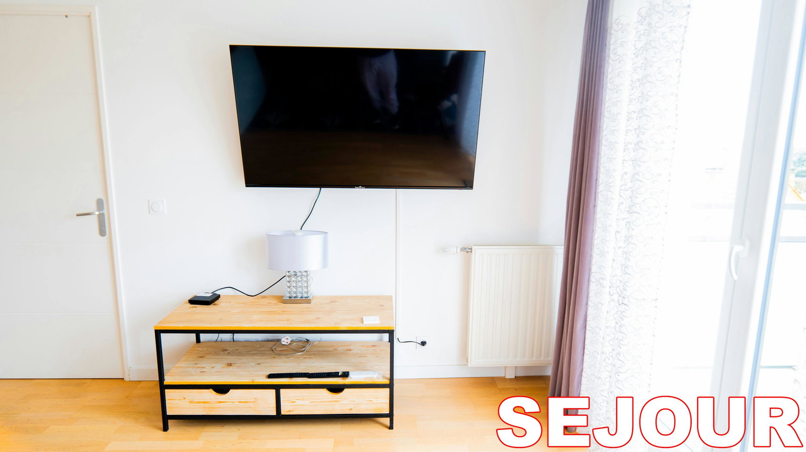 Unwind in the chic comfort of this modern living room, complete with a large flat-screen television for your entertainment. The bright, airy space is perfect for relaxing after a day of exploring the city.