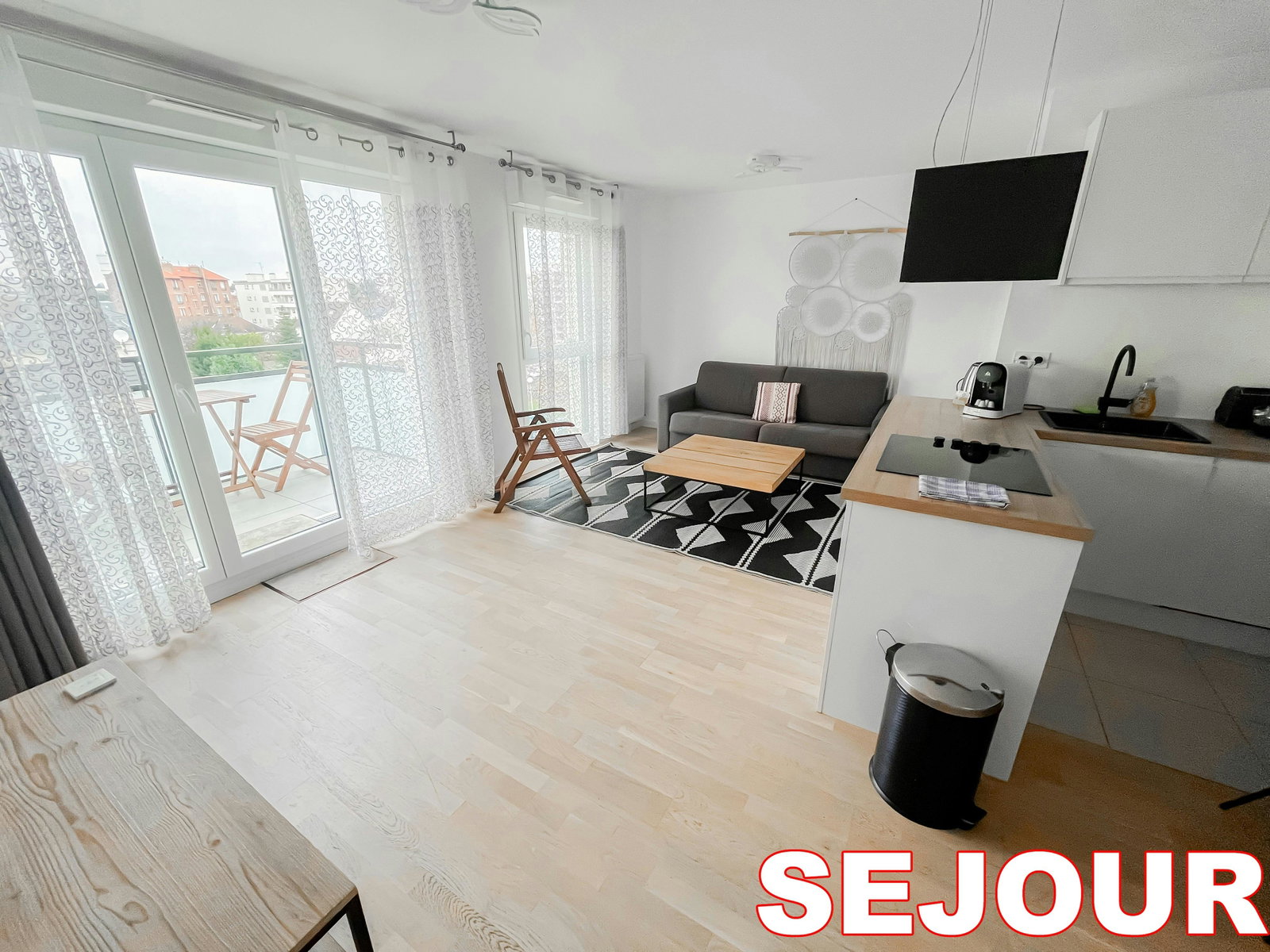This chic and contemporary apartment welcomes you with sunlight streaming through large windows, illuminating the sleek finishes and comfortable furnishings. The open layout seamlessly connects the living, dining, and kitchen areas, creating a spacious and welcoming atmosphere.