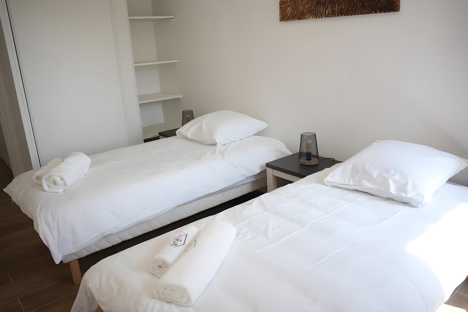 Two comfortable beds in a clear and spacious space. Large closet for your belongings. #Emails #EspaceAéré #StorageEfficient