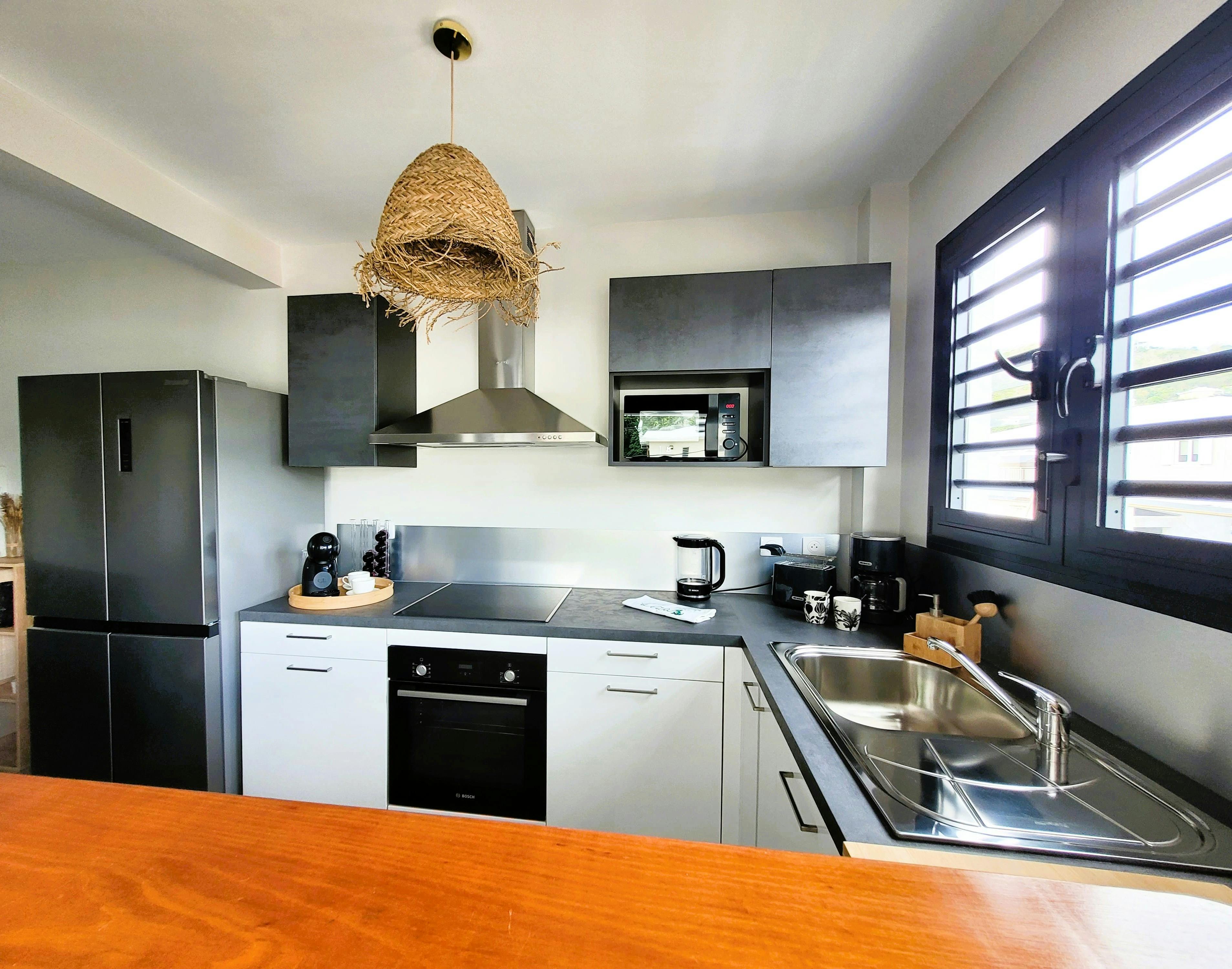 Cuisine neuve entièrement équipée : plaque, micro-ondes, four, frigo, congélateur et lave-vaisselle. Tout le nécessaire pour cuisiner comme à la maison.