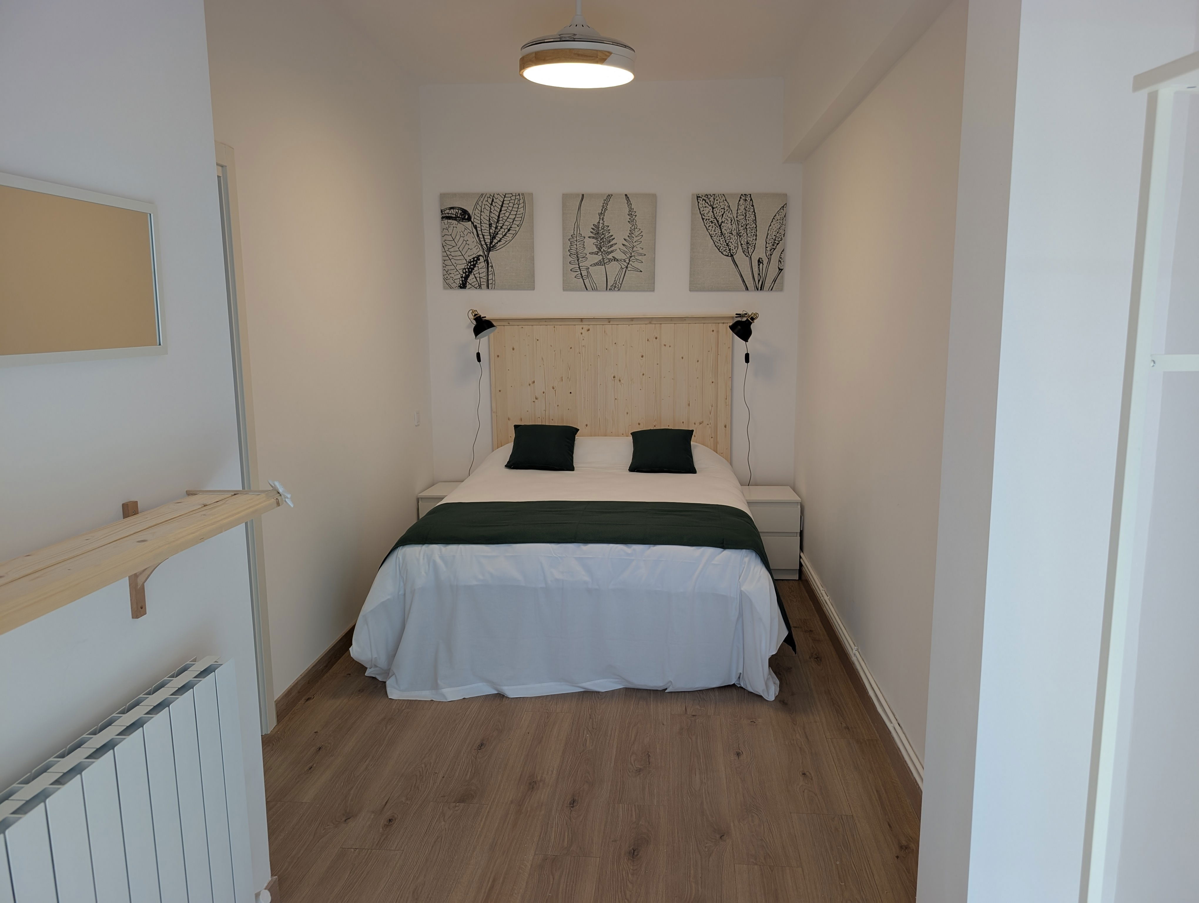 Retreat to this serene bedroom, featuring a comfortable queen-size bed and calming, modern decor after a day of exploring Bilbao.