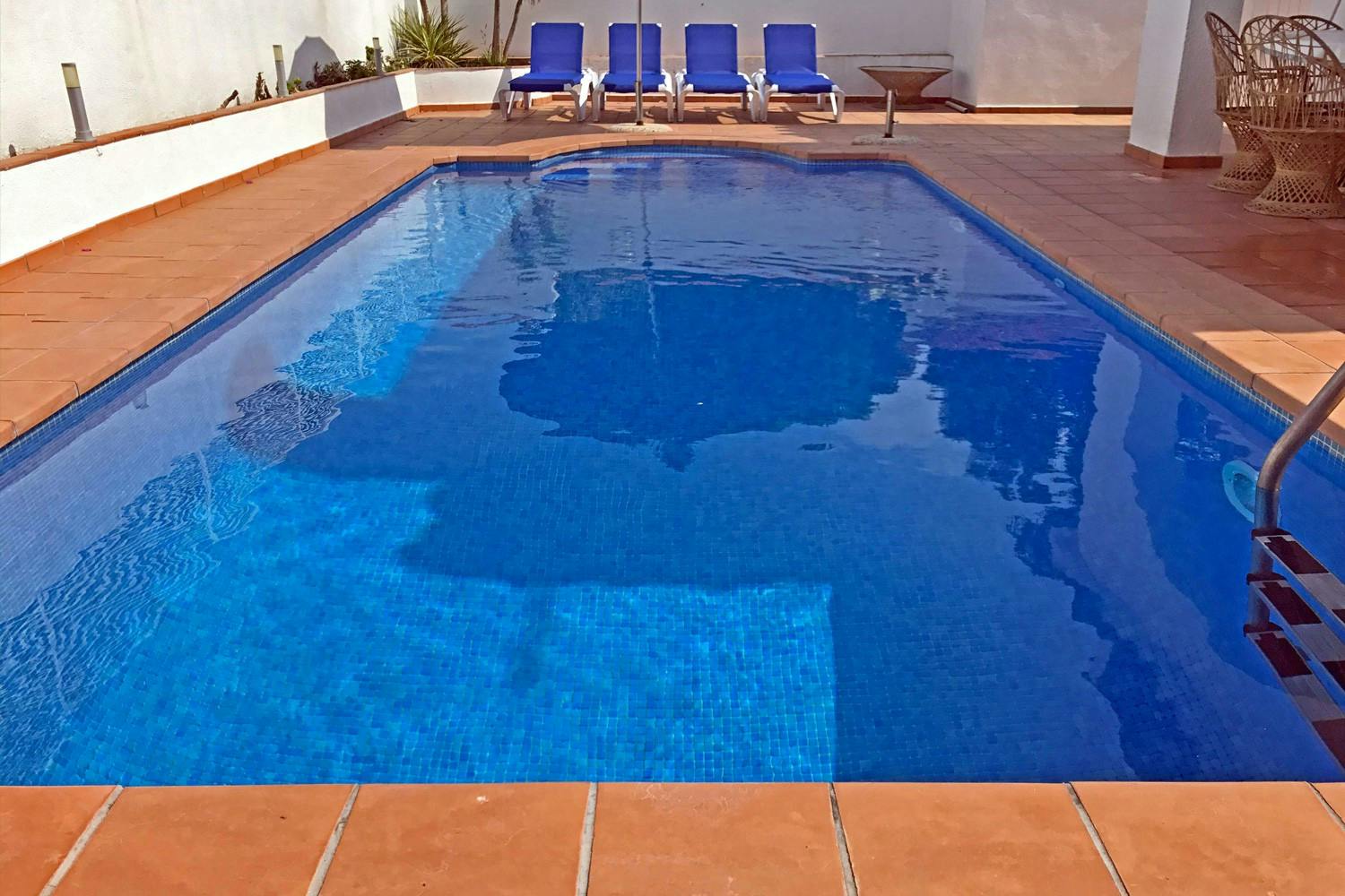 A nice cool private swimming pool behind the townhouse.