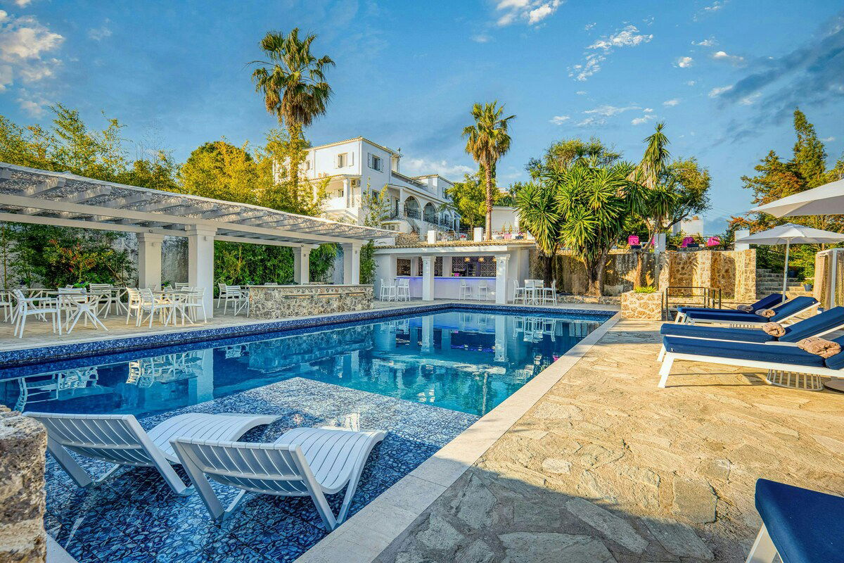 Wake up to partial sea views in the elegant Athena Room at Villa K Hotel 🌿