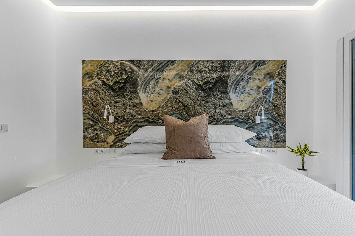 Wake up to partial sea views in the elegant Athena Room at Villa K Hotel 🌿