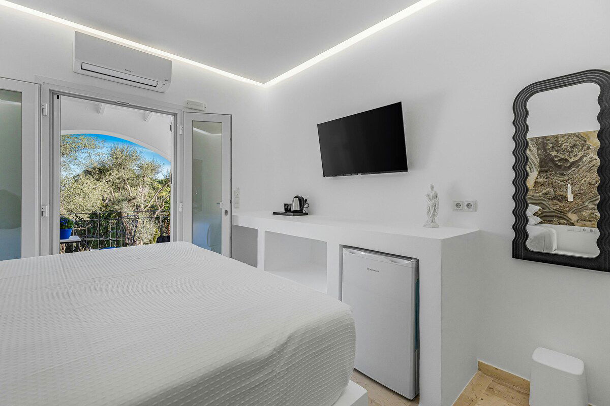 Wake up to partial sea views in the elegant Athena Room at Villa K Hotel 🌿