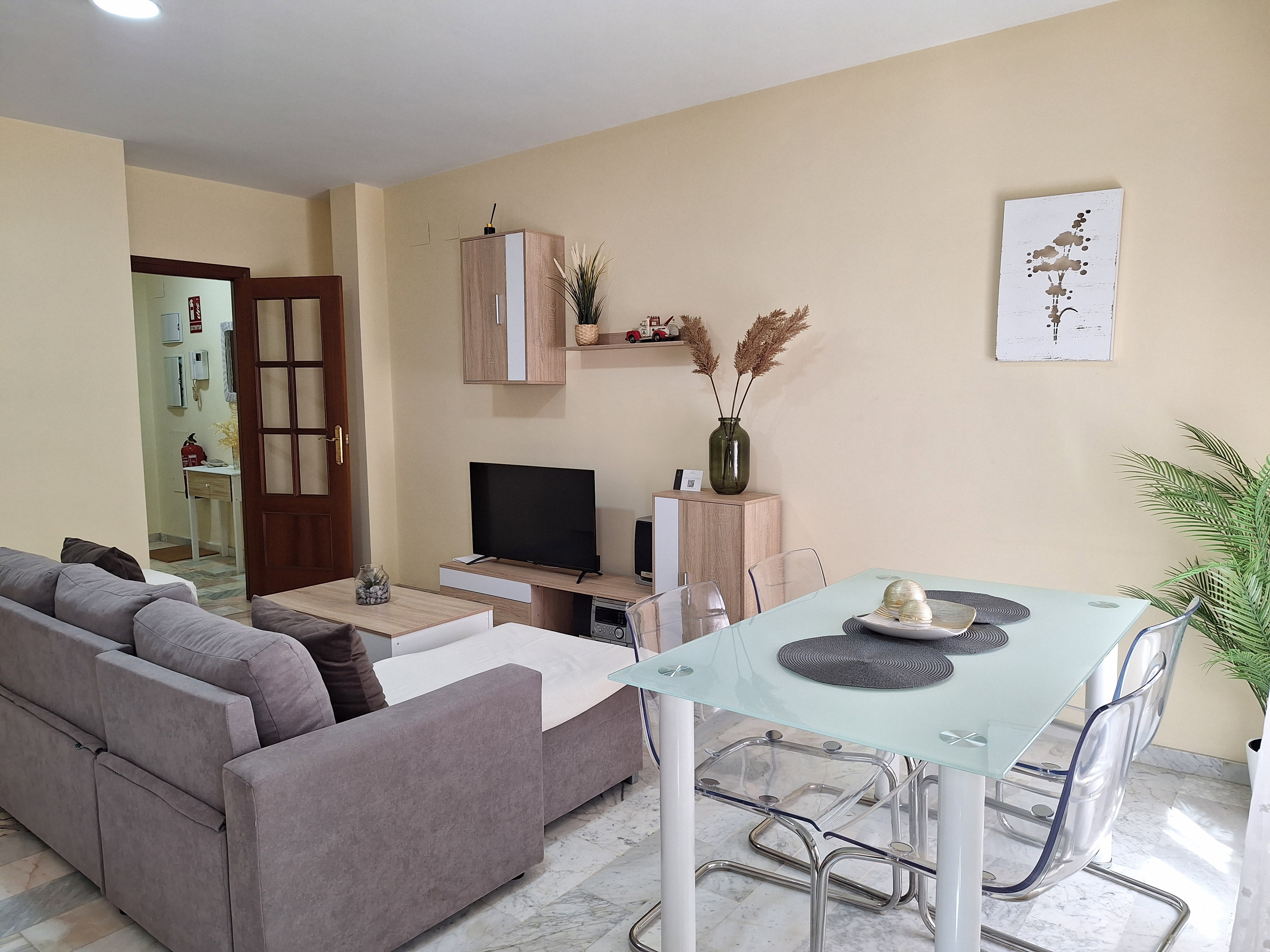 Spacious and bright living room designed for maximum comfort. It features a comfortable sofa perfect for relaxing, and a TV area.
