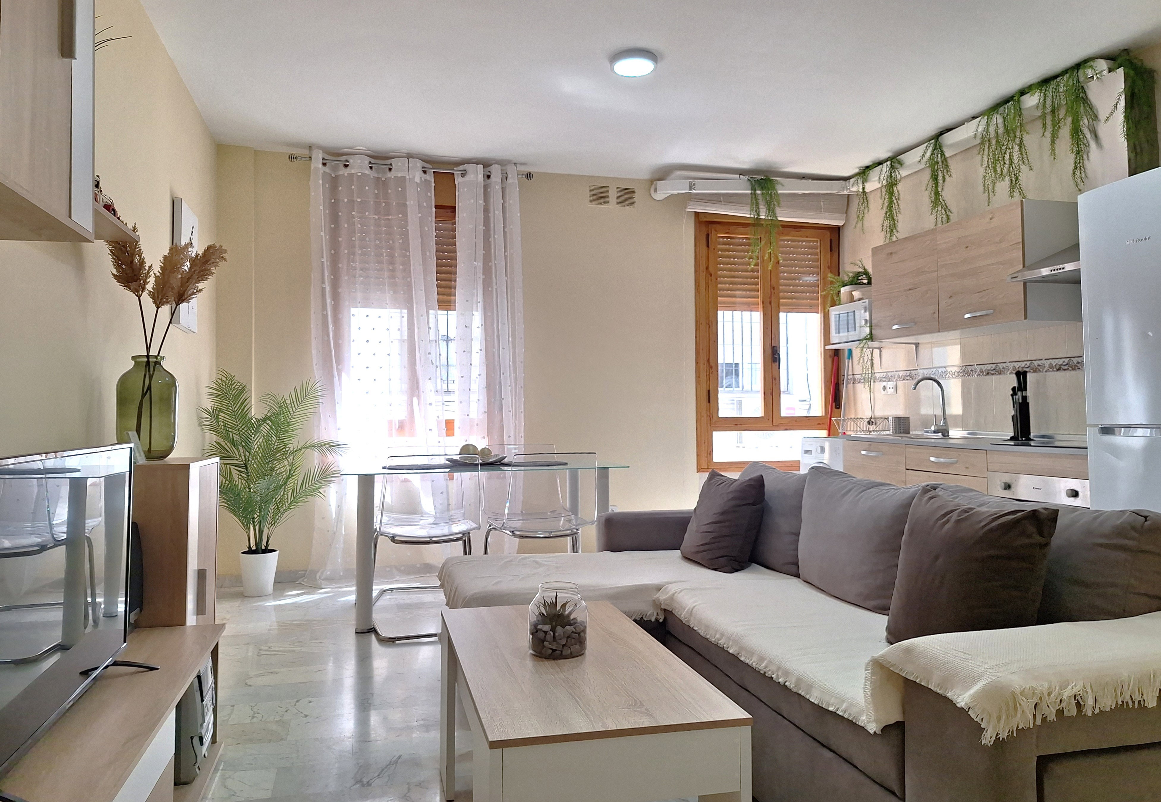 Spacious and bright living room designed for maximum comfort. It features a comfortable sofa perfect for relaxing, and a TV area.