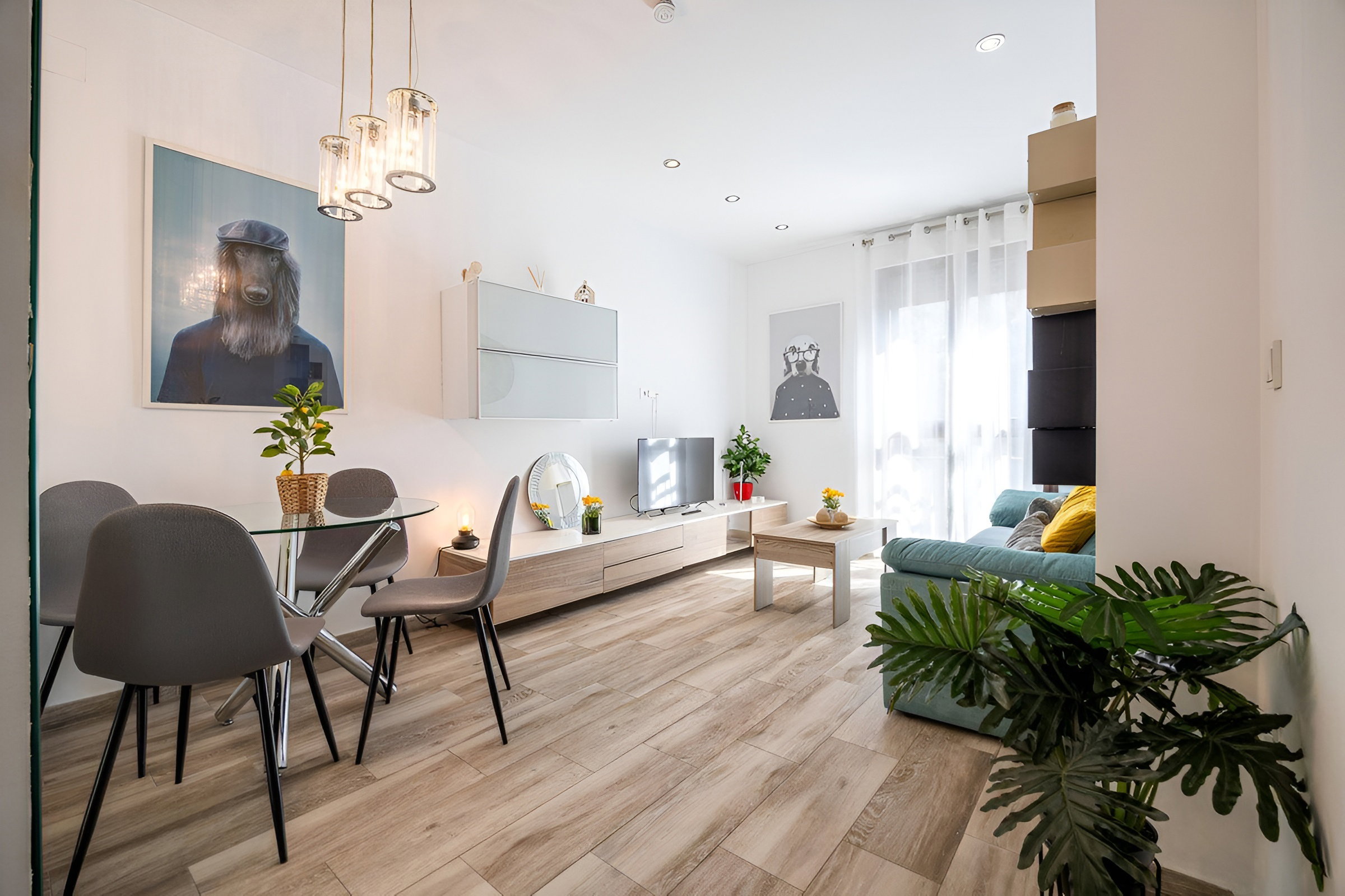 The living room, which includes a dining area, features an elaborate decor with various paintings and furnishings.