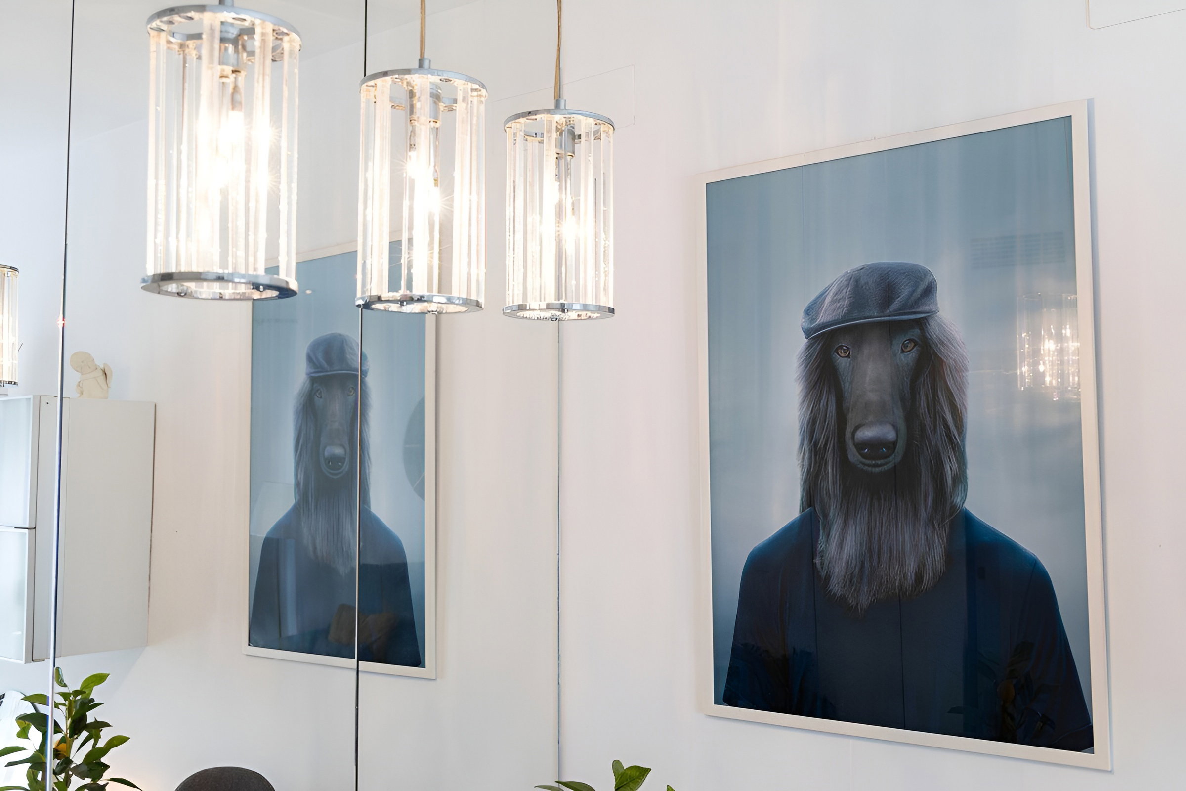 A section of the living room featuring a painting of a dog wearing a beret, as well as part of the mirror and the lighting in the dining area.