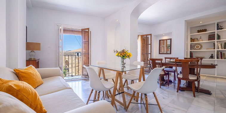Unwind in this luminous living area, featuring elegant marble floors and a balcony overlooking historic Córdoba.