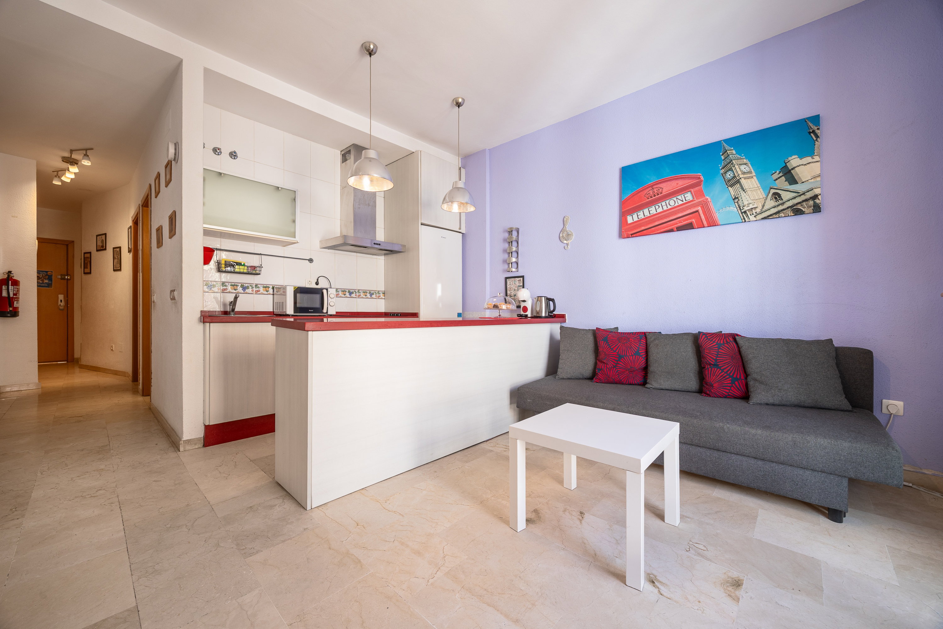 Enjoy a bright open-plan space featuring a comfortable sofa bed, modern kitchenette, and stylish breakfast bar.