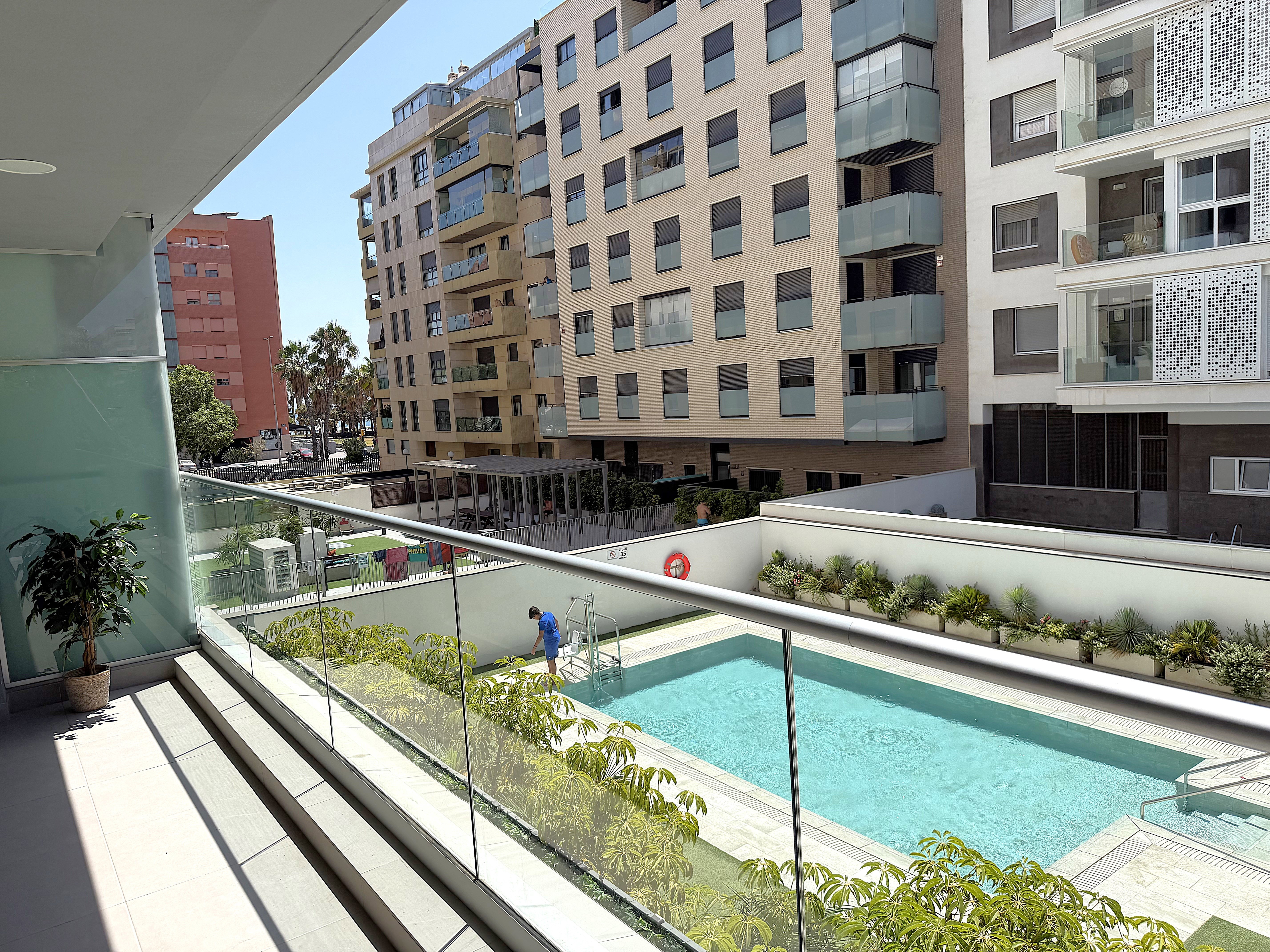 Relax on the private terrace overlooking the sparkling communal pool and modern courtyard.